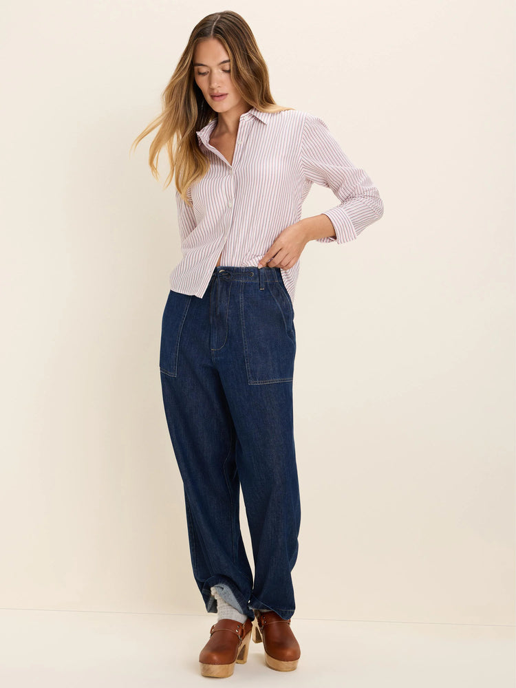 Light pink collared button-down shirt with thin vertical reddish-pink stripes and long sleeves.