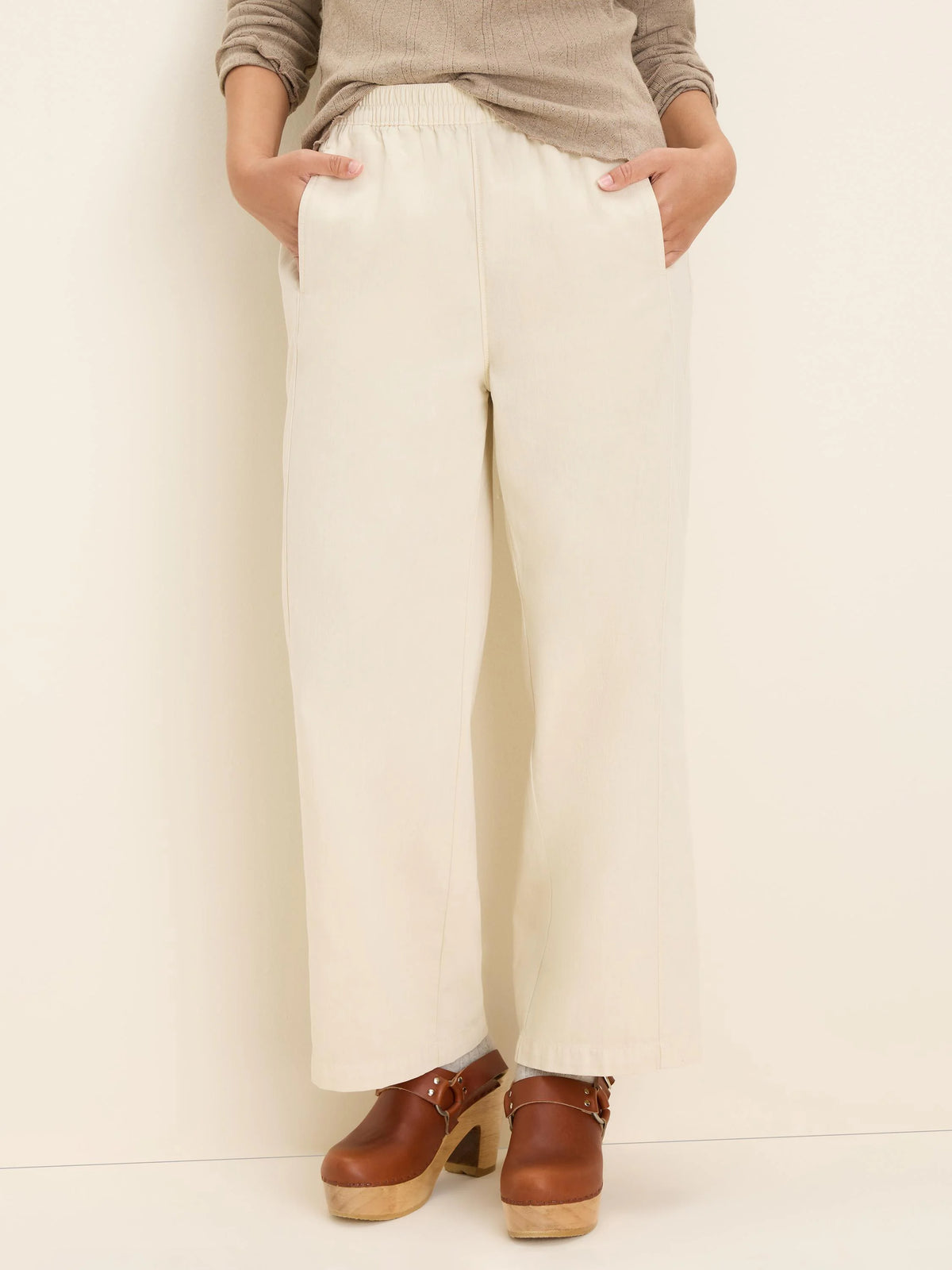 Off-white wide-leg ankle pants with an elasticized waist and side pockets.
