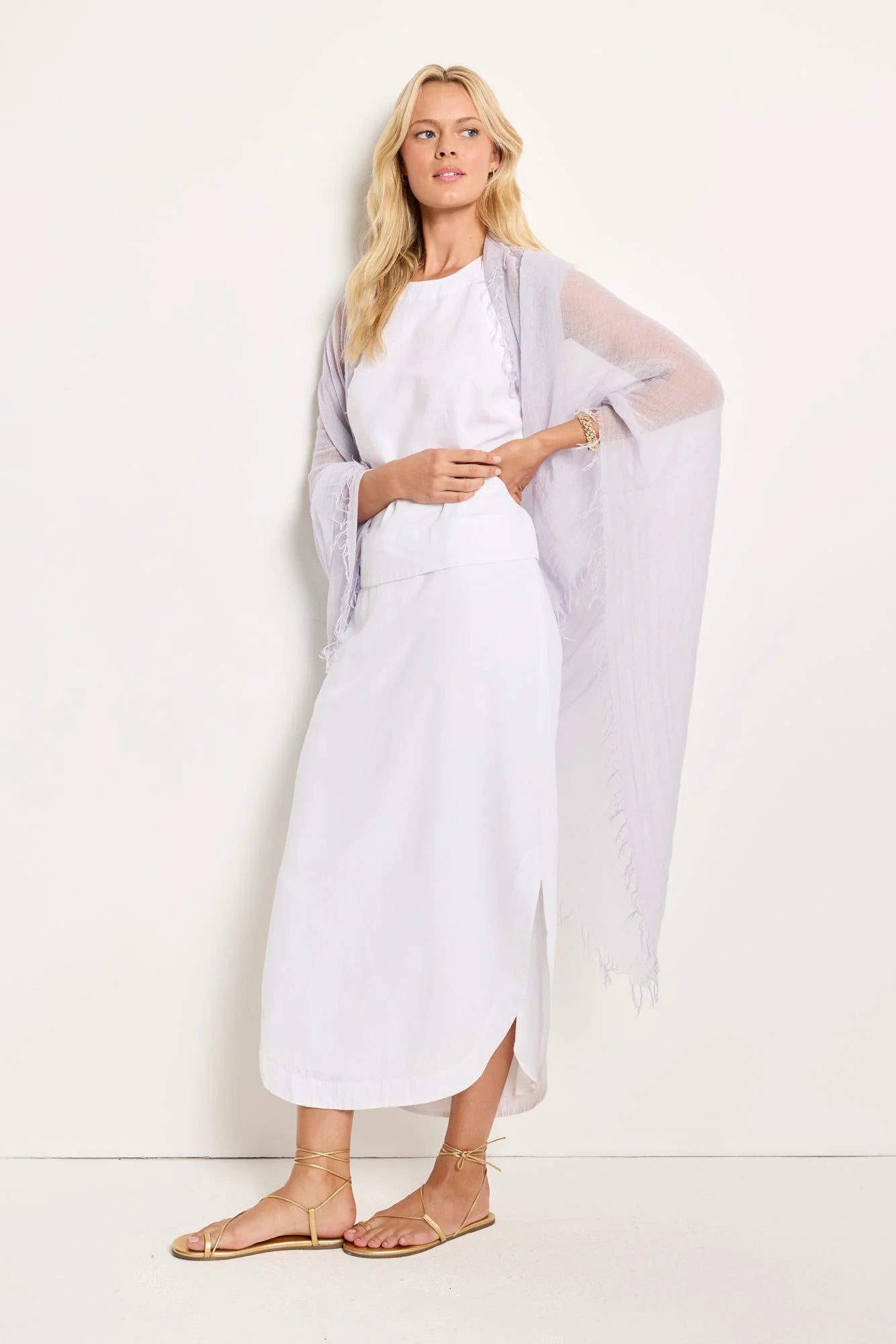 Lilac-colored scarf with frayed edges. Lightweight, semi-sheer fabric.