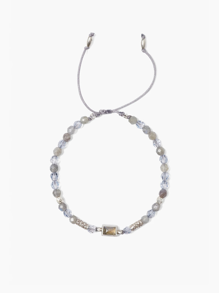 Gray beaded bracelet with light blue crystals and a rectangular labradorite centerpiece. Silver-toned accents and gray...