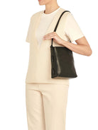 Black leather shoulder bag with a knotted strap and two vertical side loops.