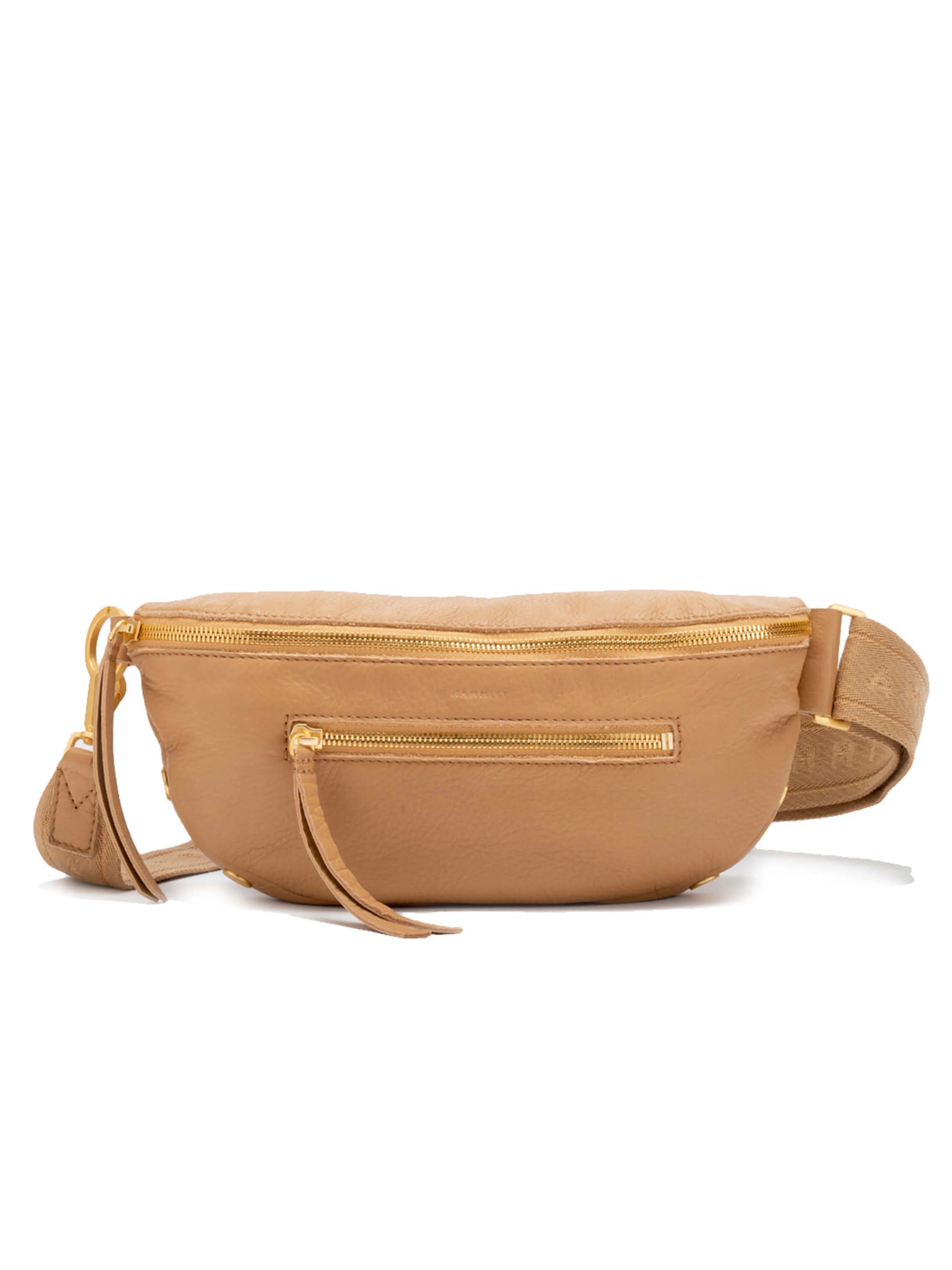 Tan, curved leather crossbody bag with gold zippers & a front pocket.