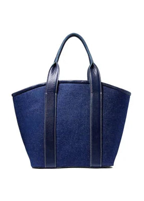 Dark blue linen top handle bag with navy leather handles and vertical trim.