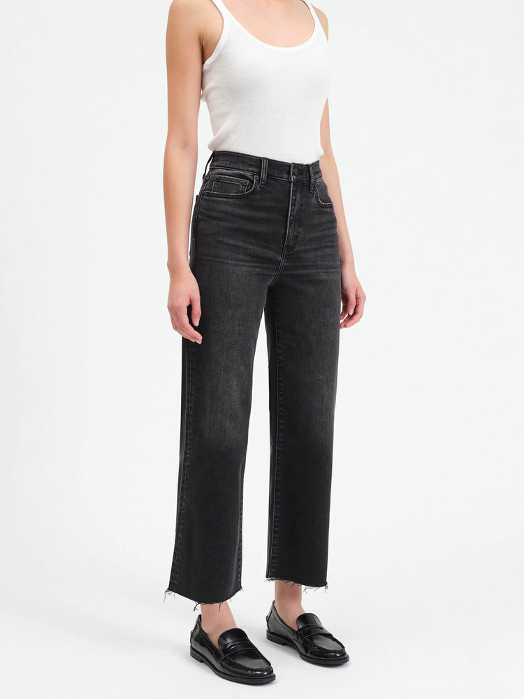Dark gray, high-waisted wide-leg pants with a frayed hem. Model wears black loafers.