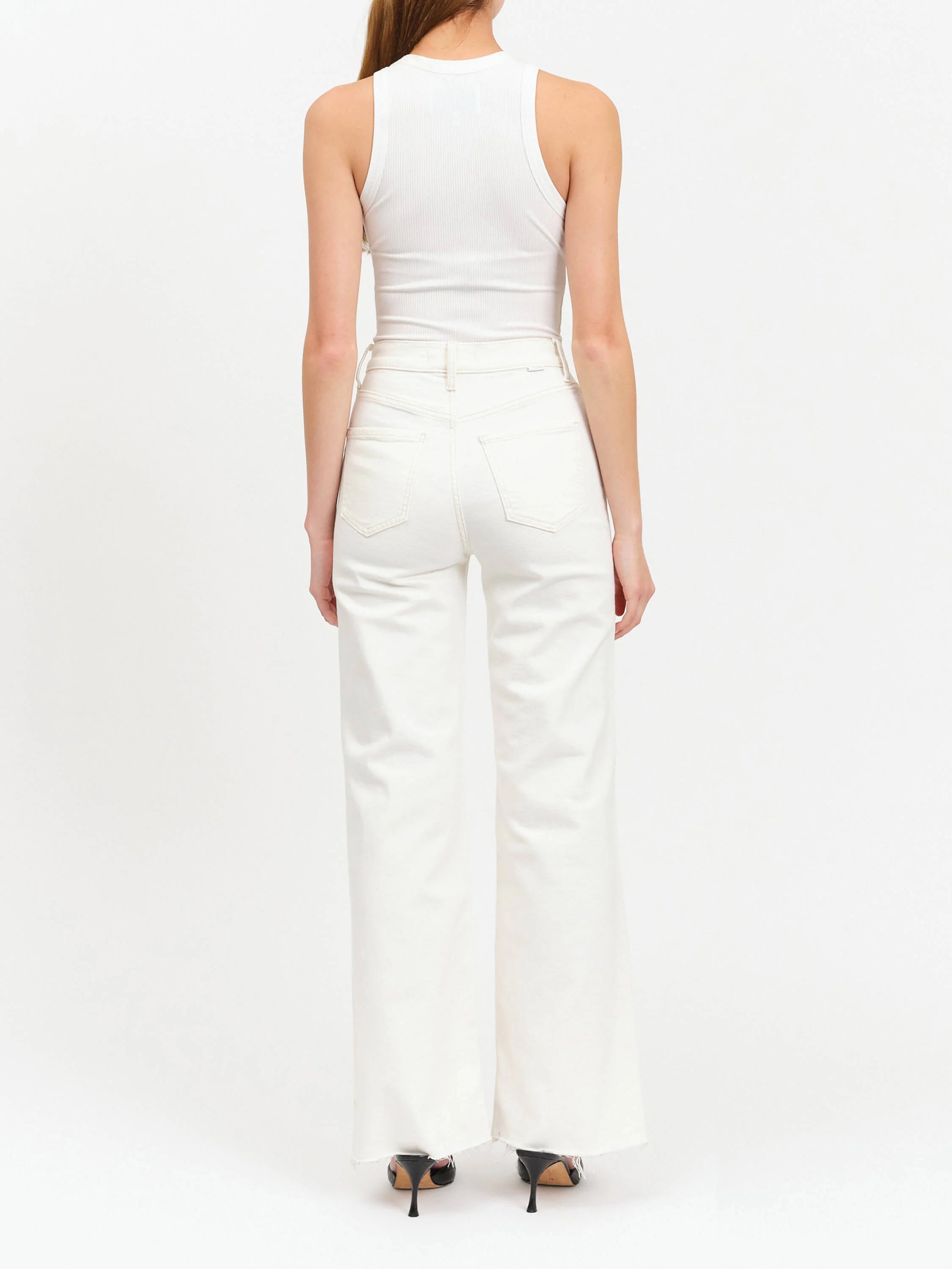 Off-white, wide-leg jeans with frayed hems. Back view shows two back pockets.