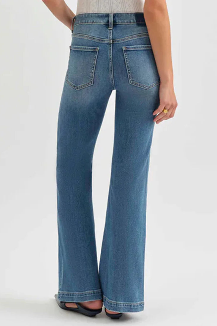 Medium blue wash mid-rise flare jeans with visible back pockets and subtle fading.
