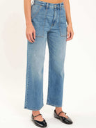 Light blue wide-leg jeans with front utility patch pockets, high waist, and distinctive vertical leg seams.