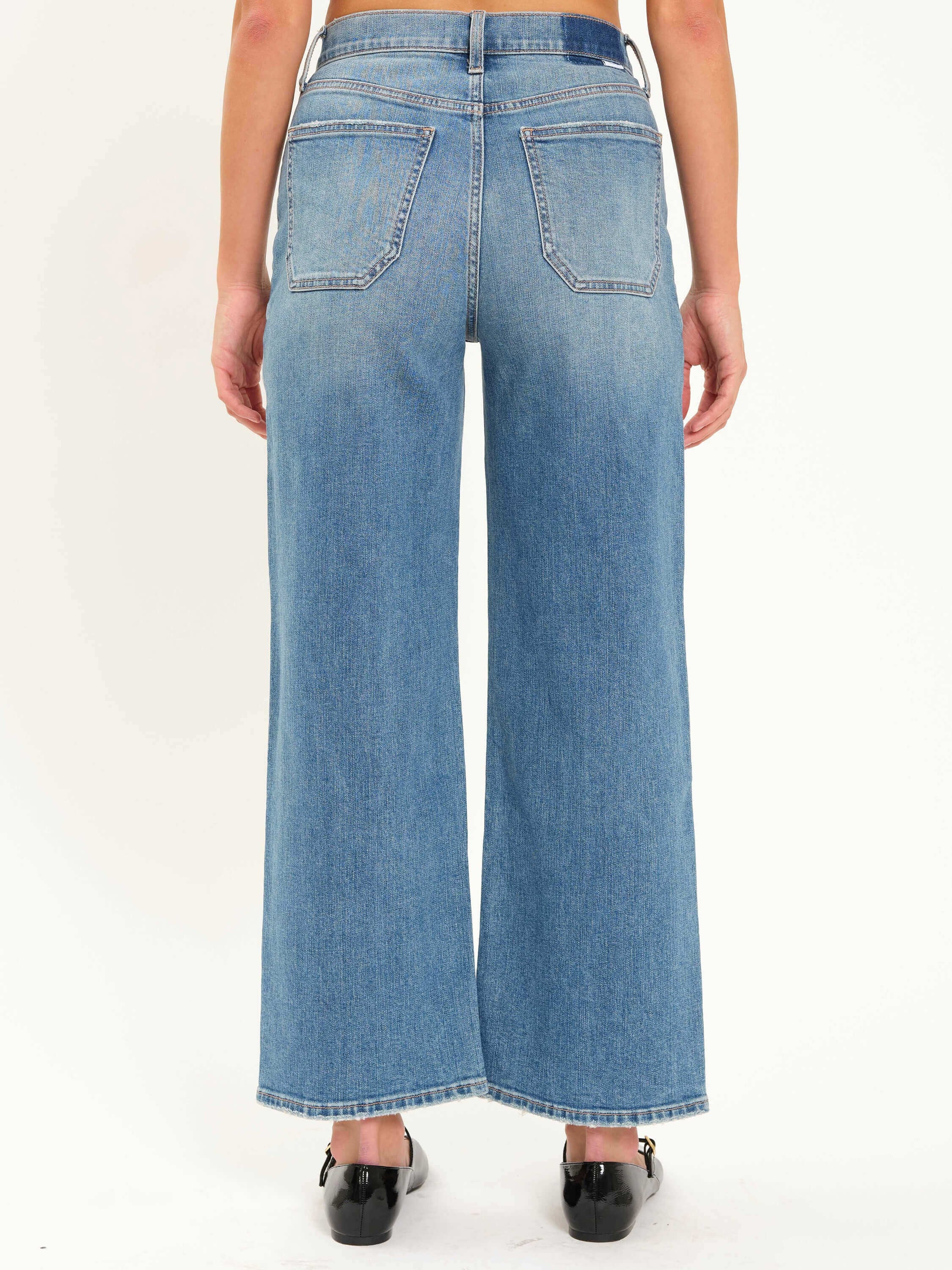 Medium blue faded wide-leg jeans with rear patch pockets.