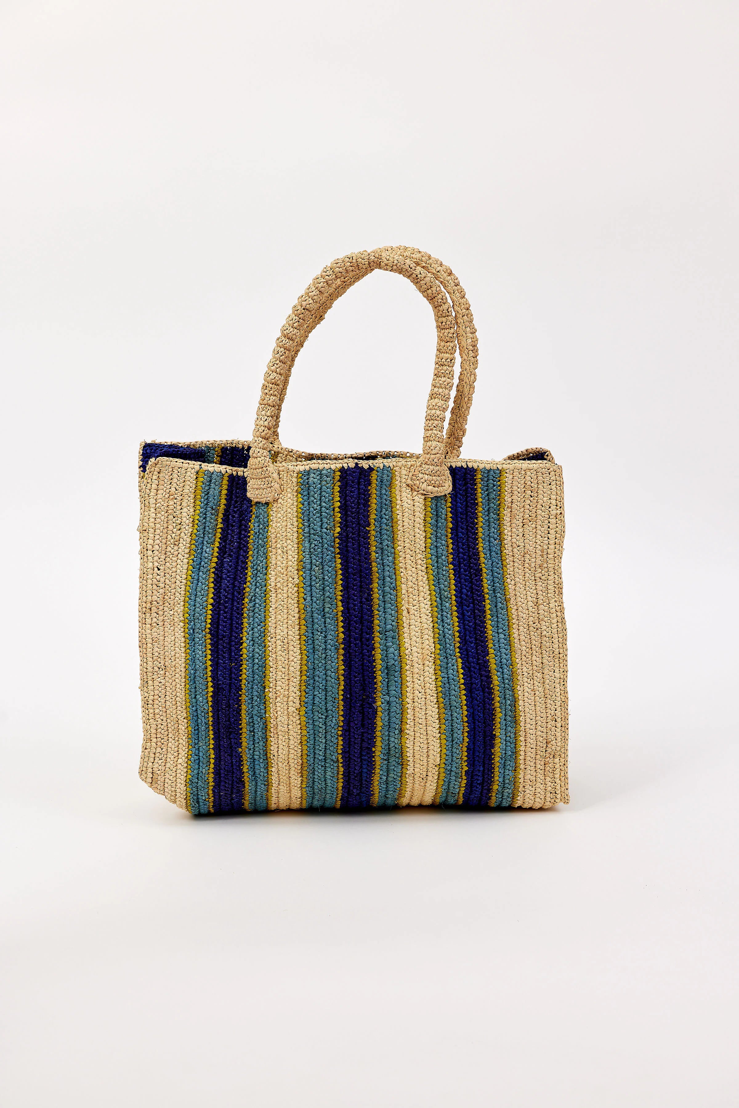 Woven straw tote with vertical stripes: natural, navy, teal, and thin yellow-green. Matching woven handles.