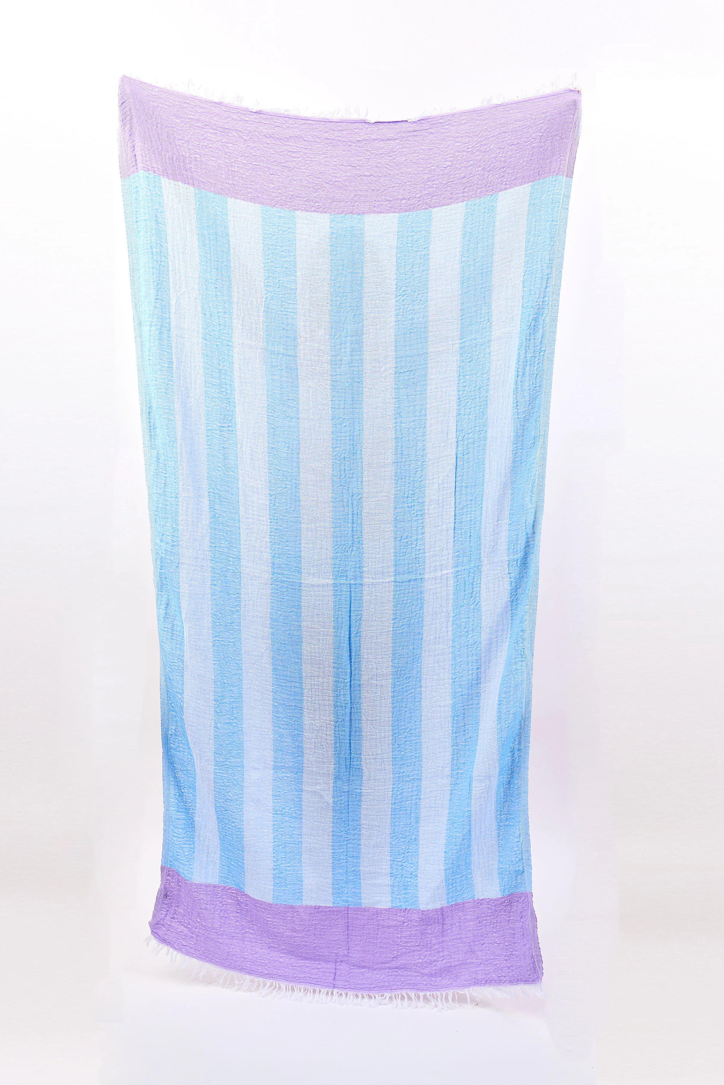 Light blue and white vertically striped towel with purple top and bottom bands, and fringed edges. Crinkled texture.