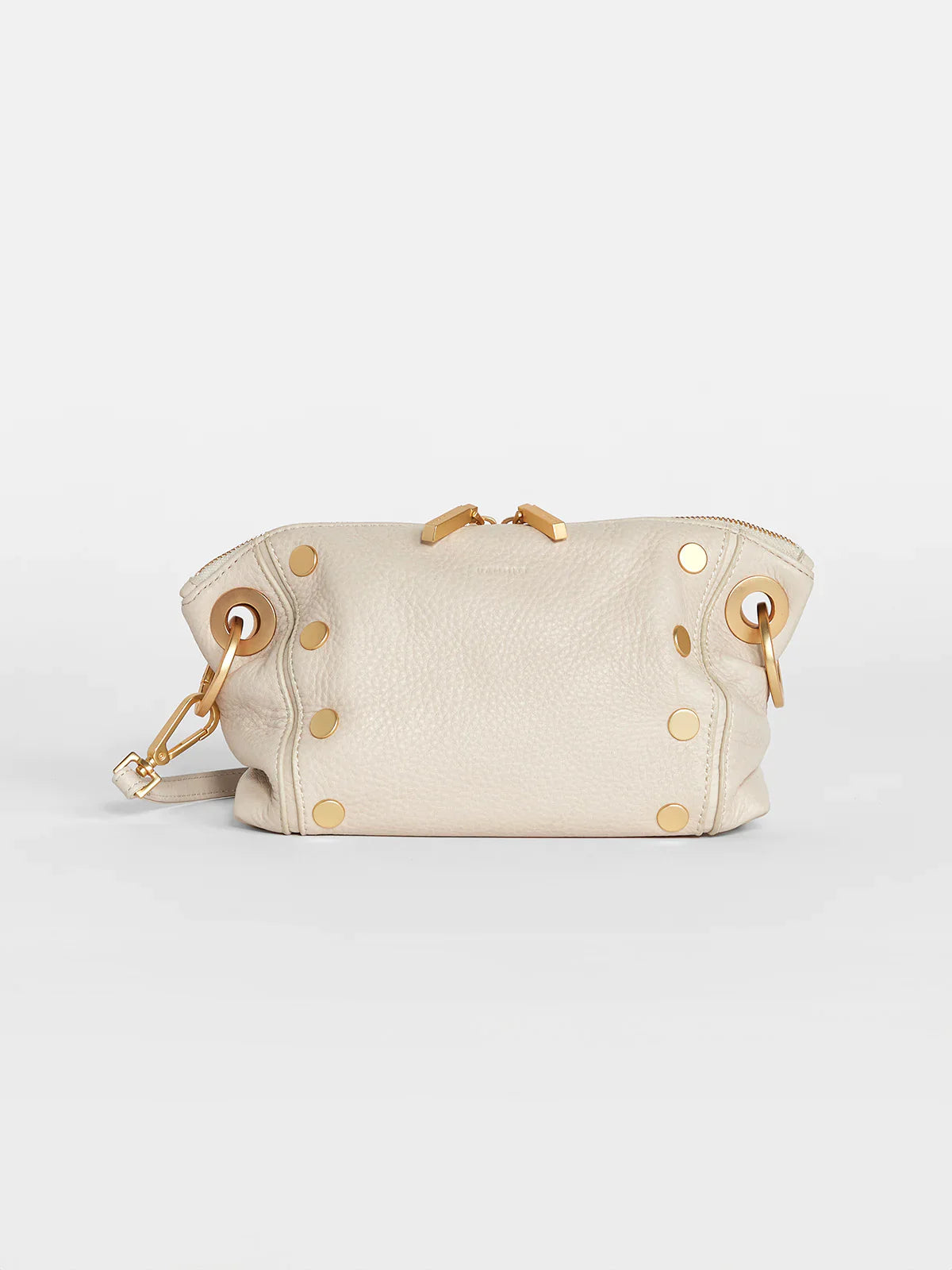 Off-white leather crossbody clutch with gold zipper and studs.  Small, with a detachable strap.