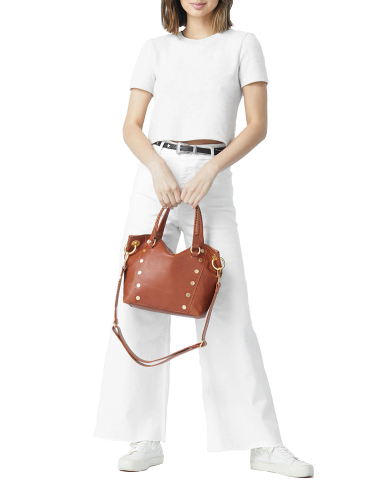 Brown leather medium-sized handbag with gold accents, shoulder strap, and braided handles.