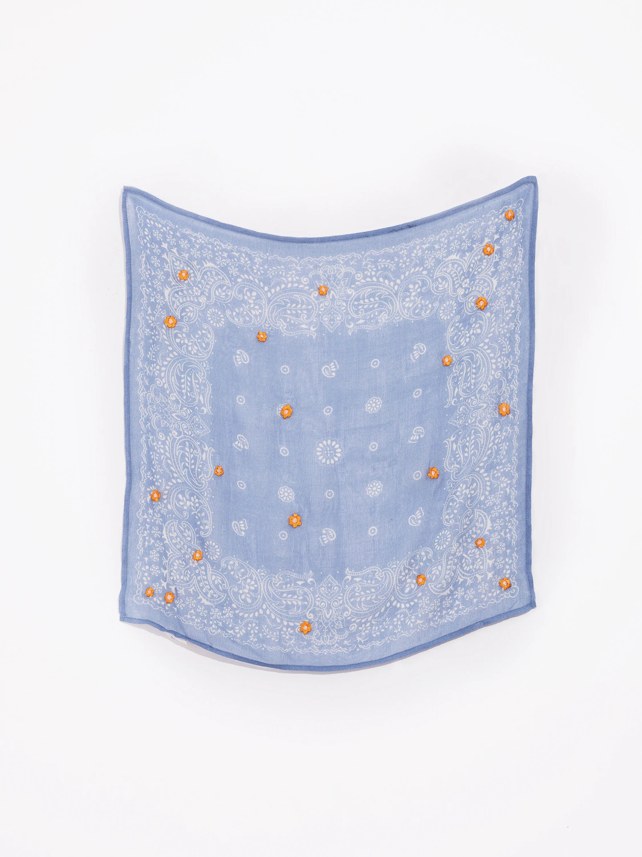 Light blue bandana with white paisley pattern and small orange embroidered flowers.