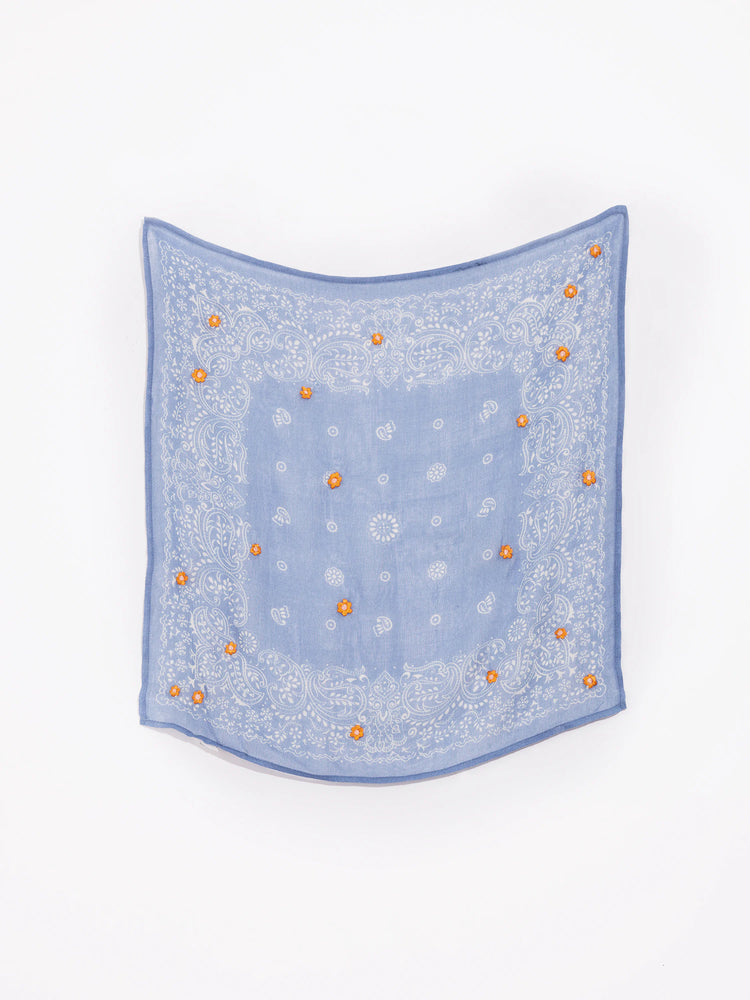 Light blue bandana with white paisley pattern and small orange embroidered flowers.