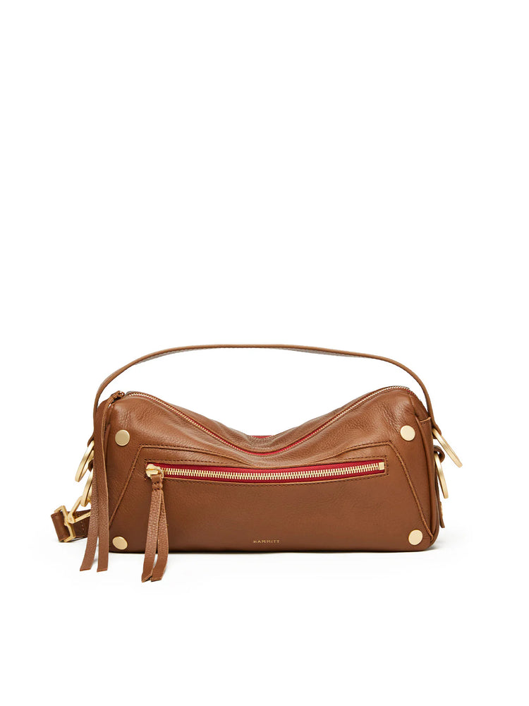 Brown leather elongated bag with red-lined gold zippers, gold studs, and a brown strap.