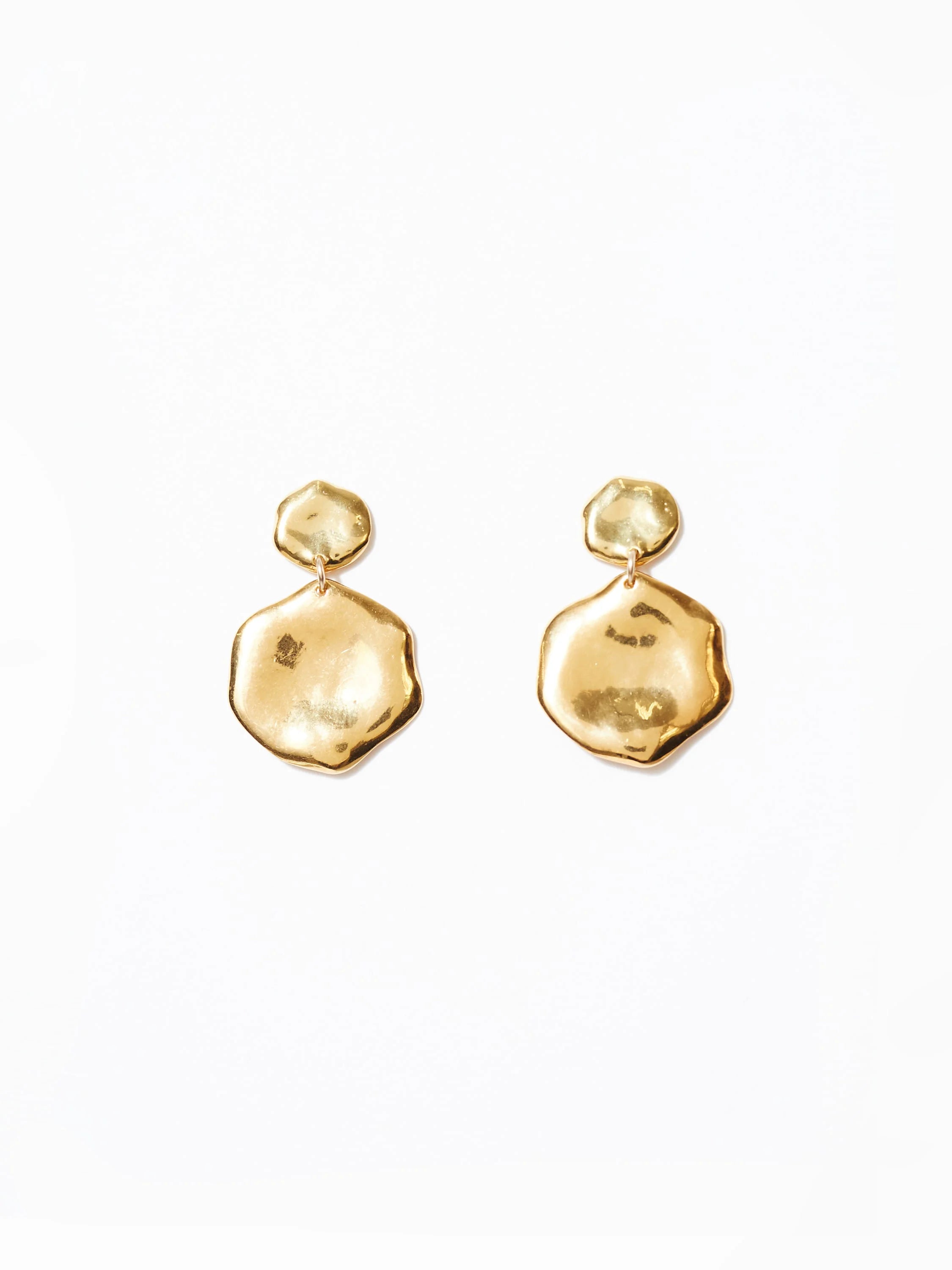 Pair of gold hammered drop earrings. Each has a small top piece and a larger, irregular lower piece.