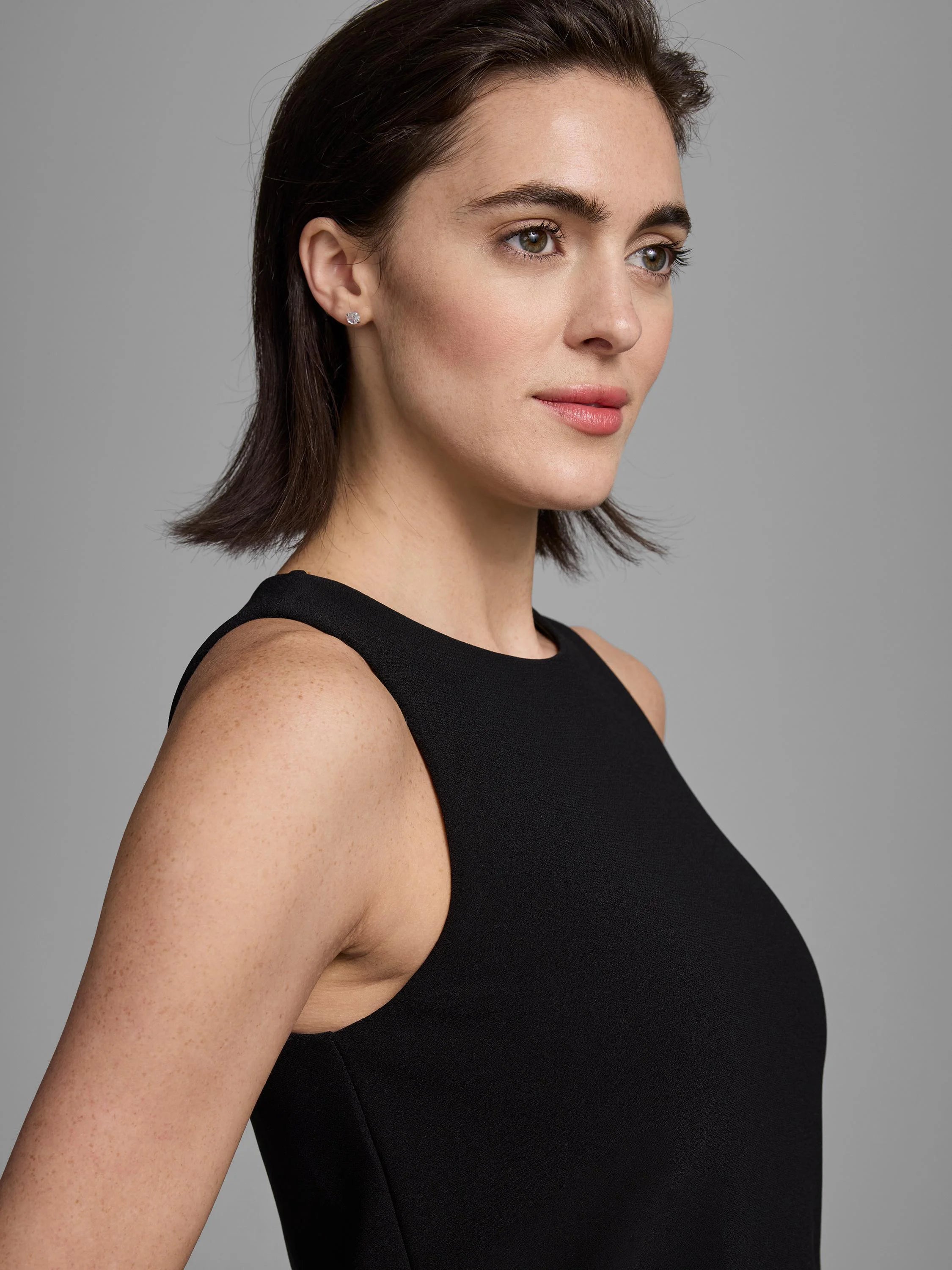 Black knit scuba high-neck tank top, sleeveless.