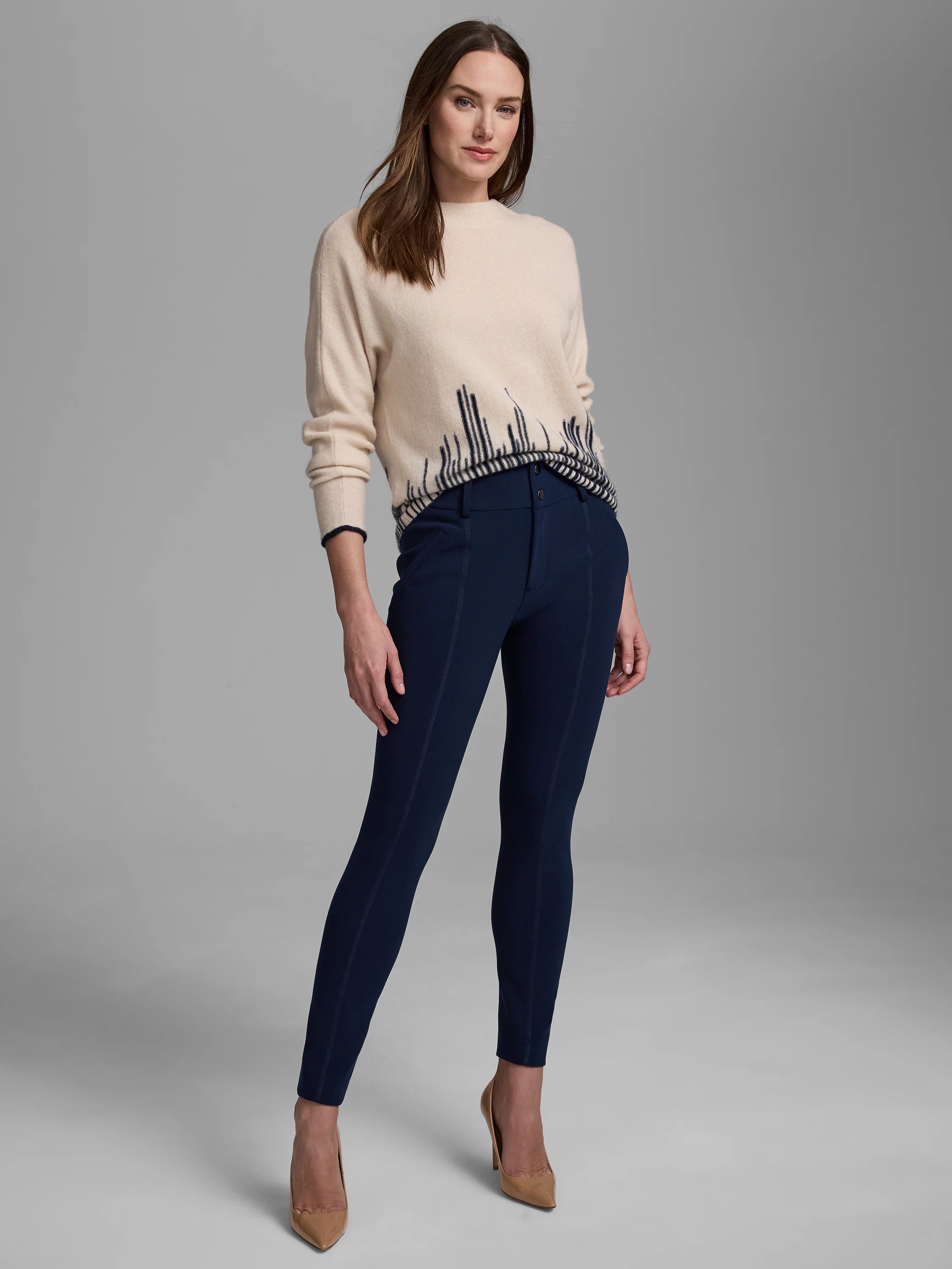 Cream sweater with dark blue flame stitch pattern along the hem and cuffs.