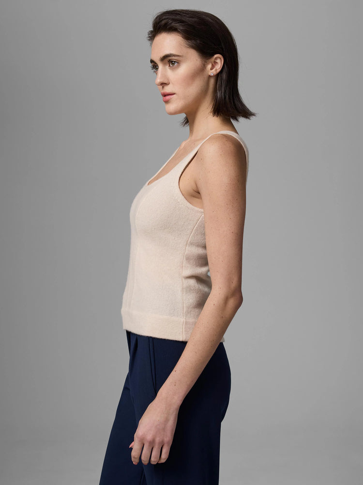 Light beige tank top with scoop neck and visible vertical corset-style seams on a model.