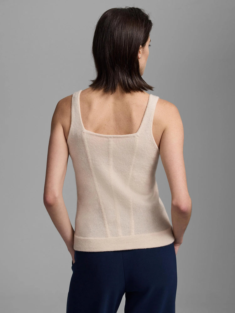 Back of a light beige cashmere tank. Square neckline, wide straps, fitted bodice with vertical ribbed shaping details.