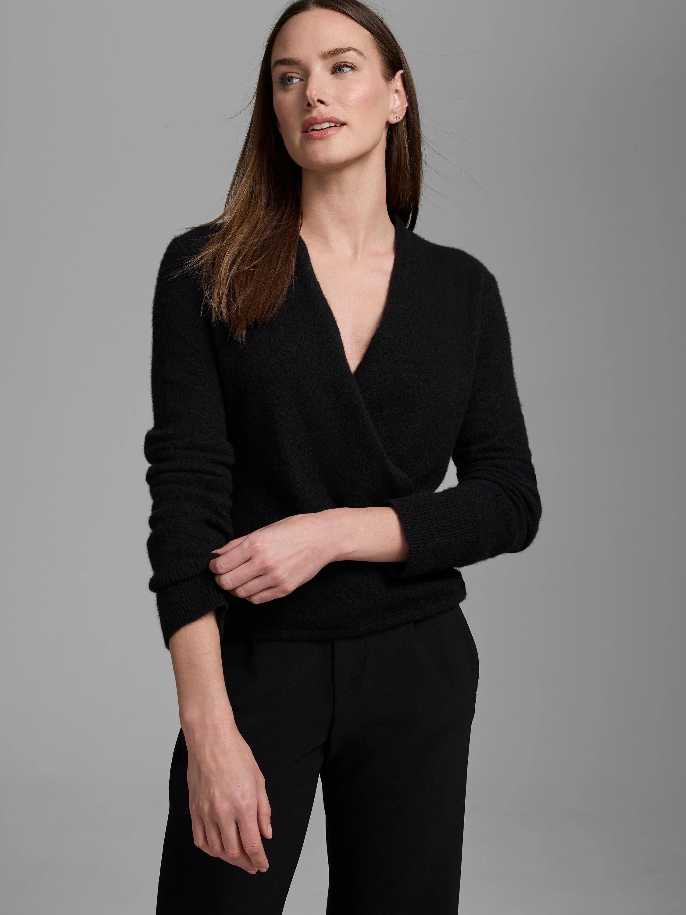 Black wrap-front cardigan with a deep V-neck and long sleeves.