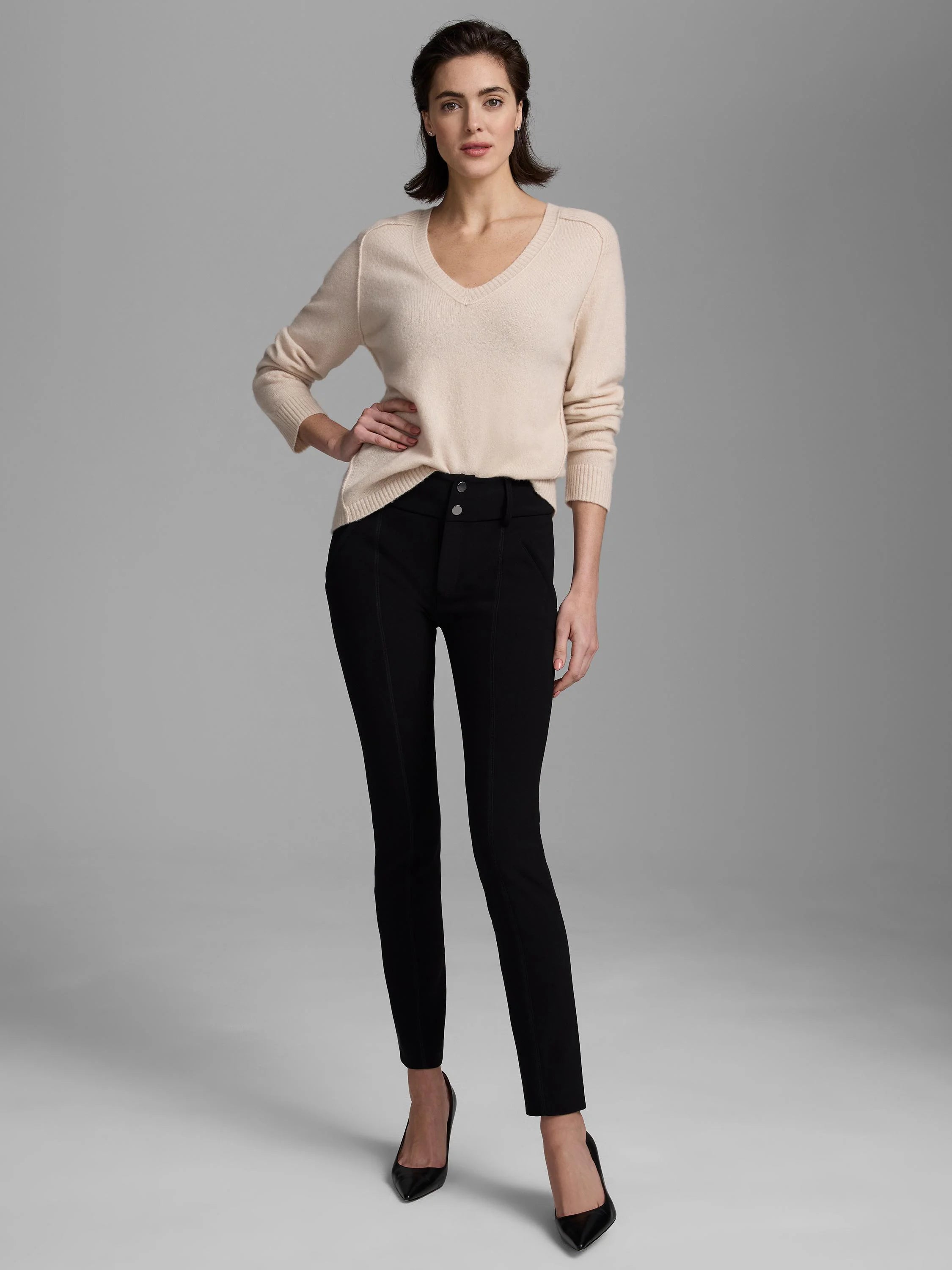 Light beige, fine knit V-neck sweater with long sleeves, ribbed cuffs, and a ribbed hem.