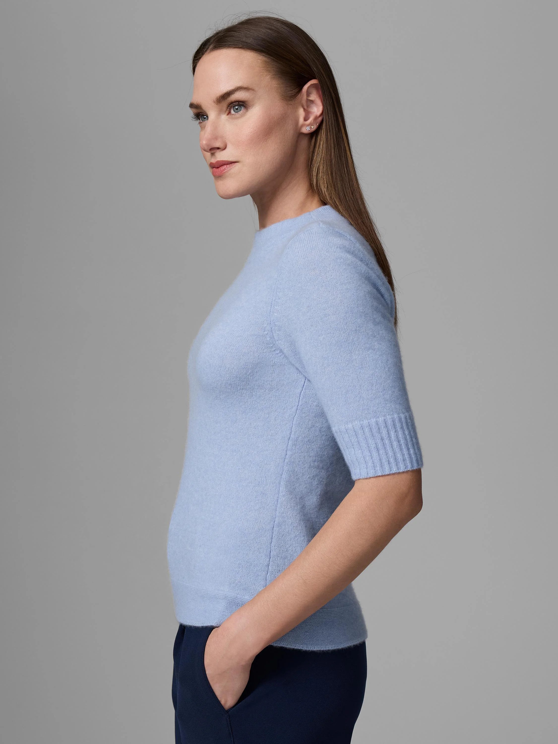 Light blue mock neck sweater, fitted with elbow-length sleeves, ribbed cuffs & hem. Appears soft.