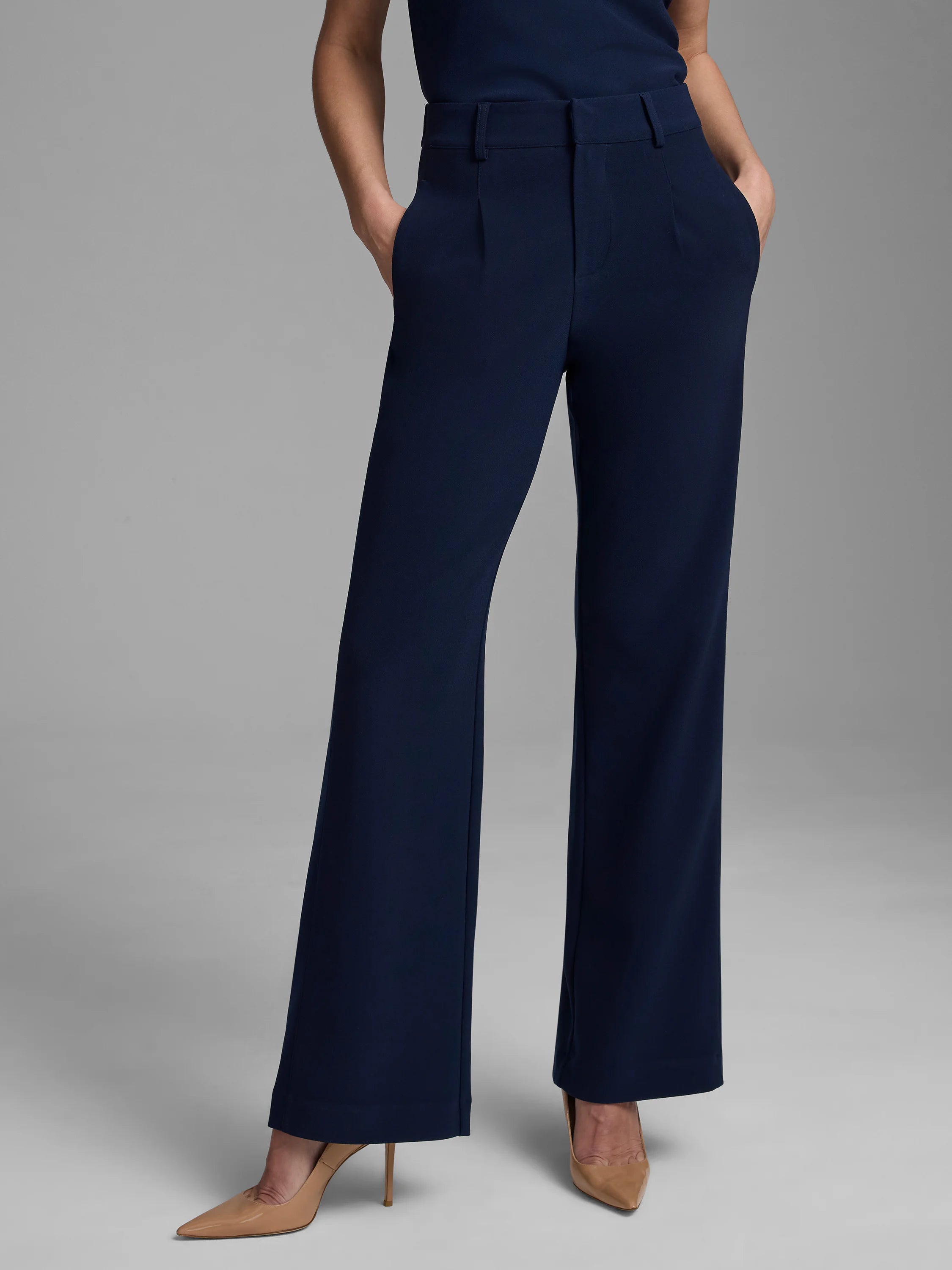 Navy wide-leg trousers. High-waisted, flat front with pleats, side pockets, and belt loops.