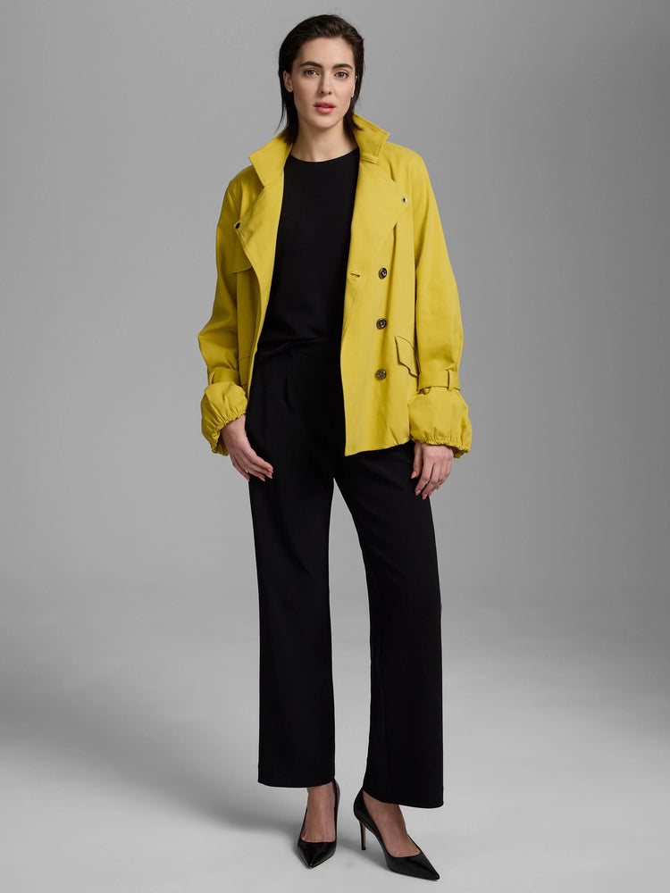 Bright yellow short trench coat, double-breasted with a classic collar, flap pockets, and gathered cuffs.