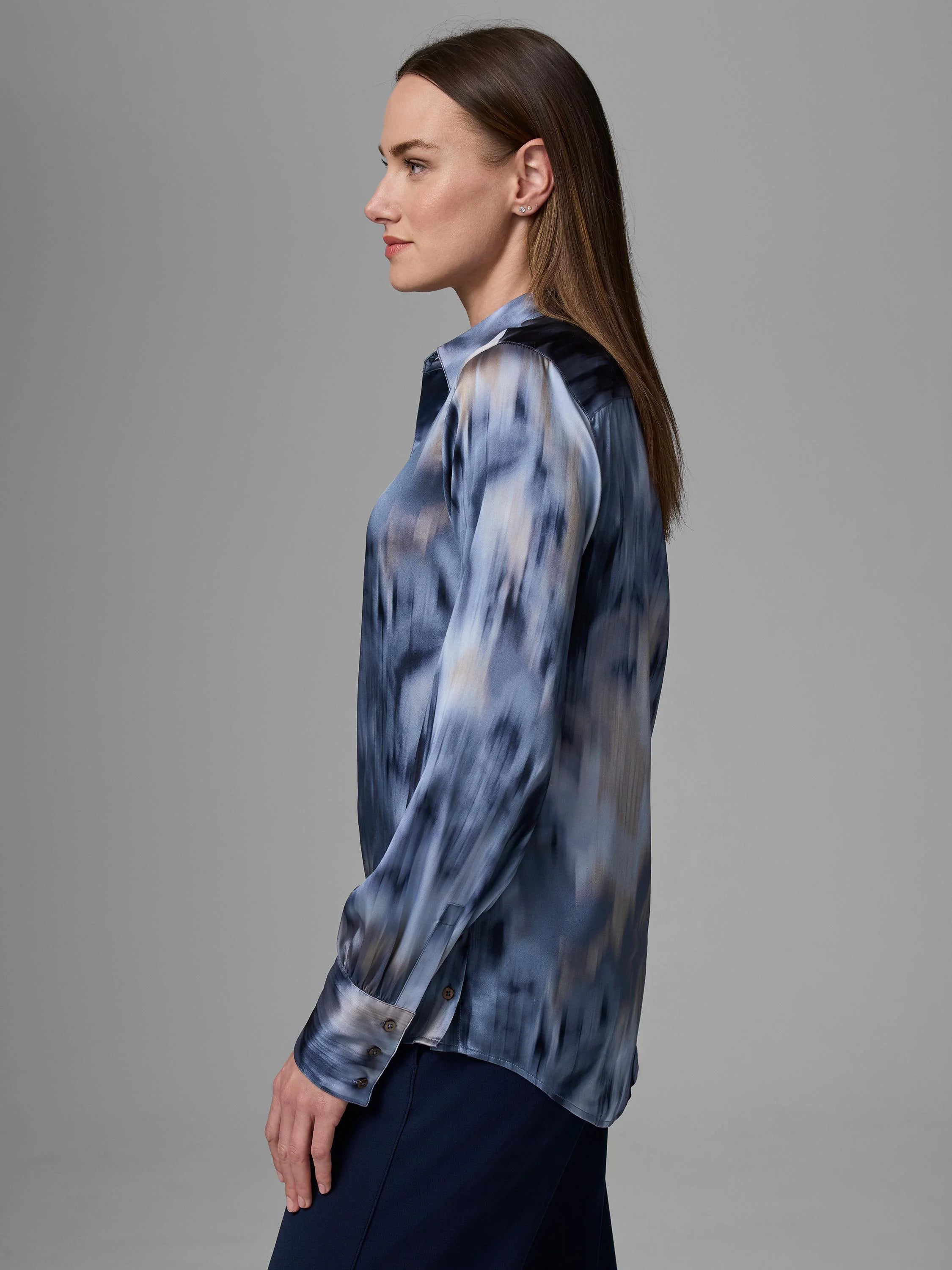 Collared, long-sleeved shirt with blue, gray, and tan streaky abstract pattern, worn on a model.