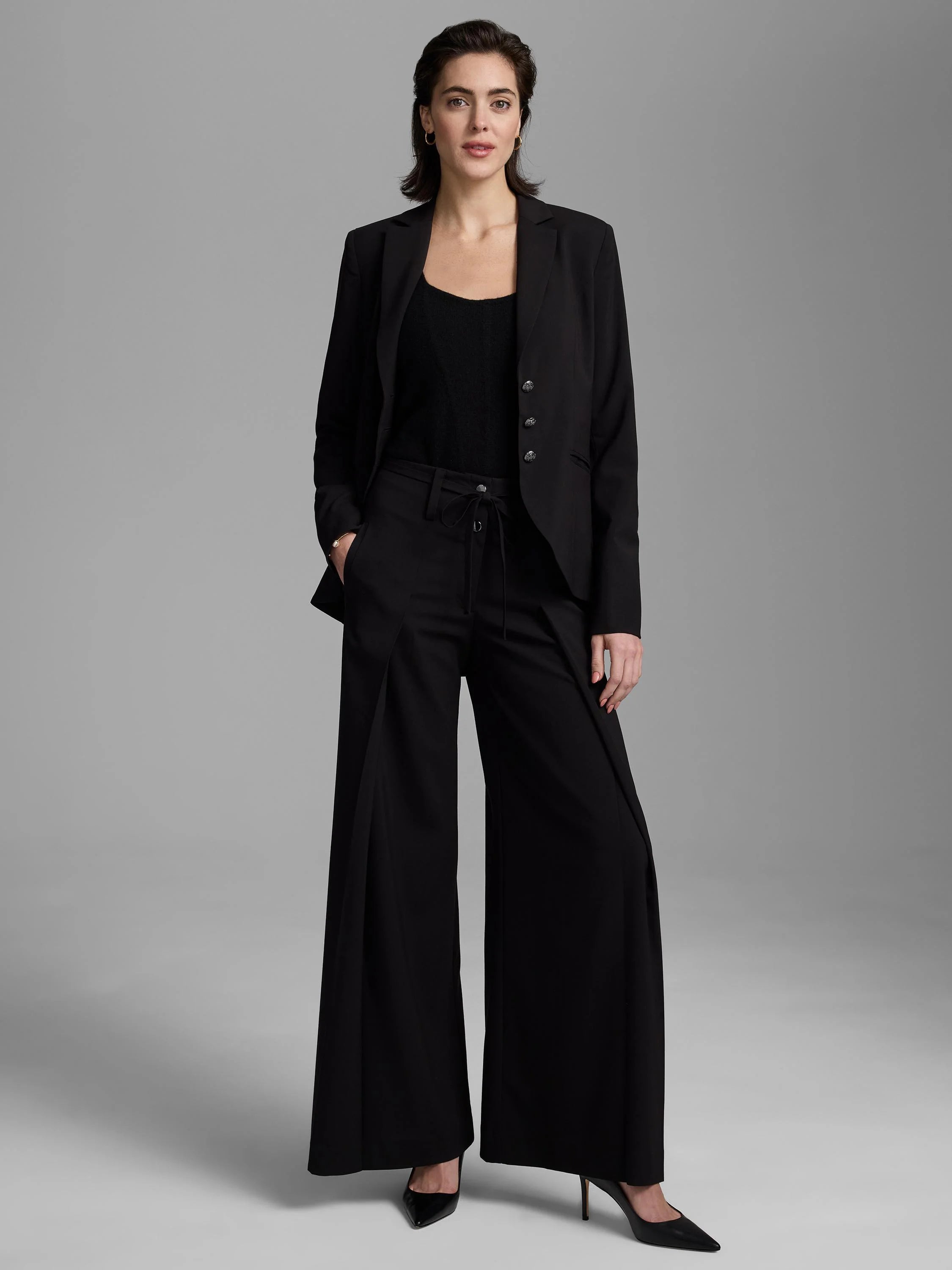 Black wide-leg pants with a high-rise fit and adjustable tie waist.