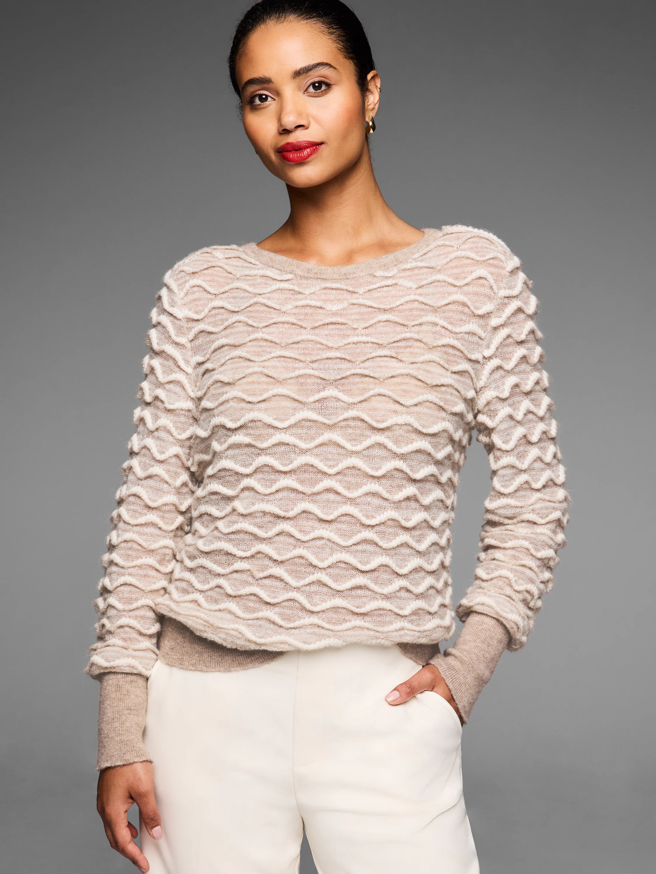 Light tan crewneck sweater with a raised, all-over cream-colored wavy stitch pattern.