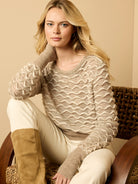 Oatmeal sweater with raised cream-colored wavy stitching throughout. Features a ribbed crew neck and cuffs.