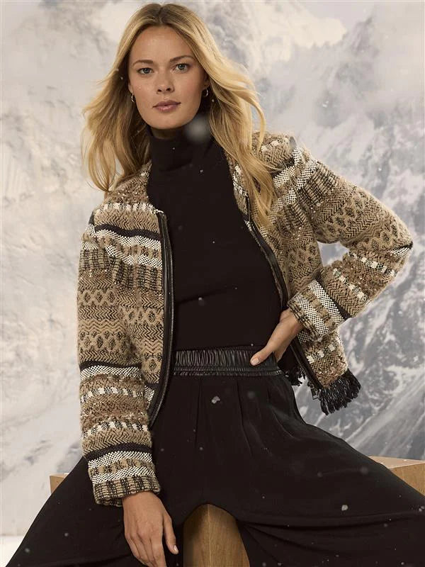 Short knit jacket with complex tan, black, and white woven geometric patterns. Features a black front zipper and fringe...