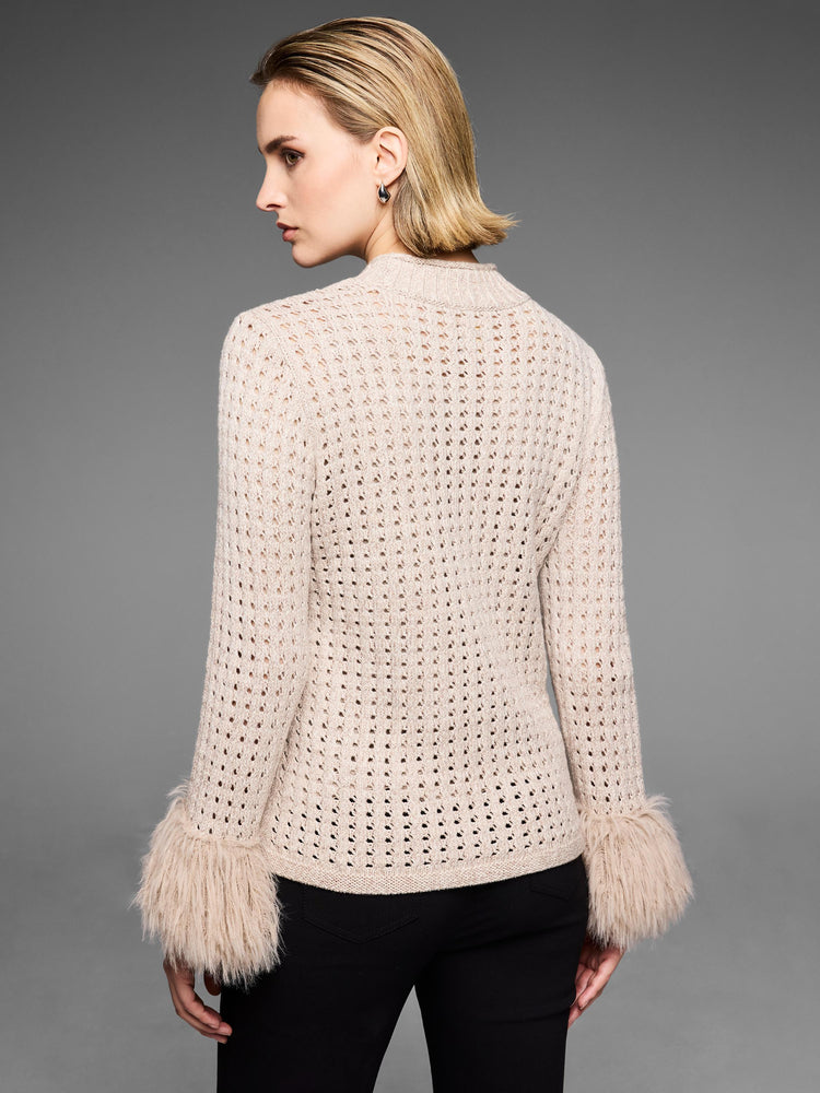 This fitted beige open-knit cardigan features a funnel neck and shaggy faux fur cuffs.