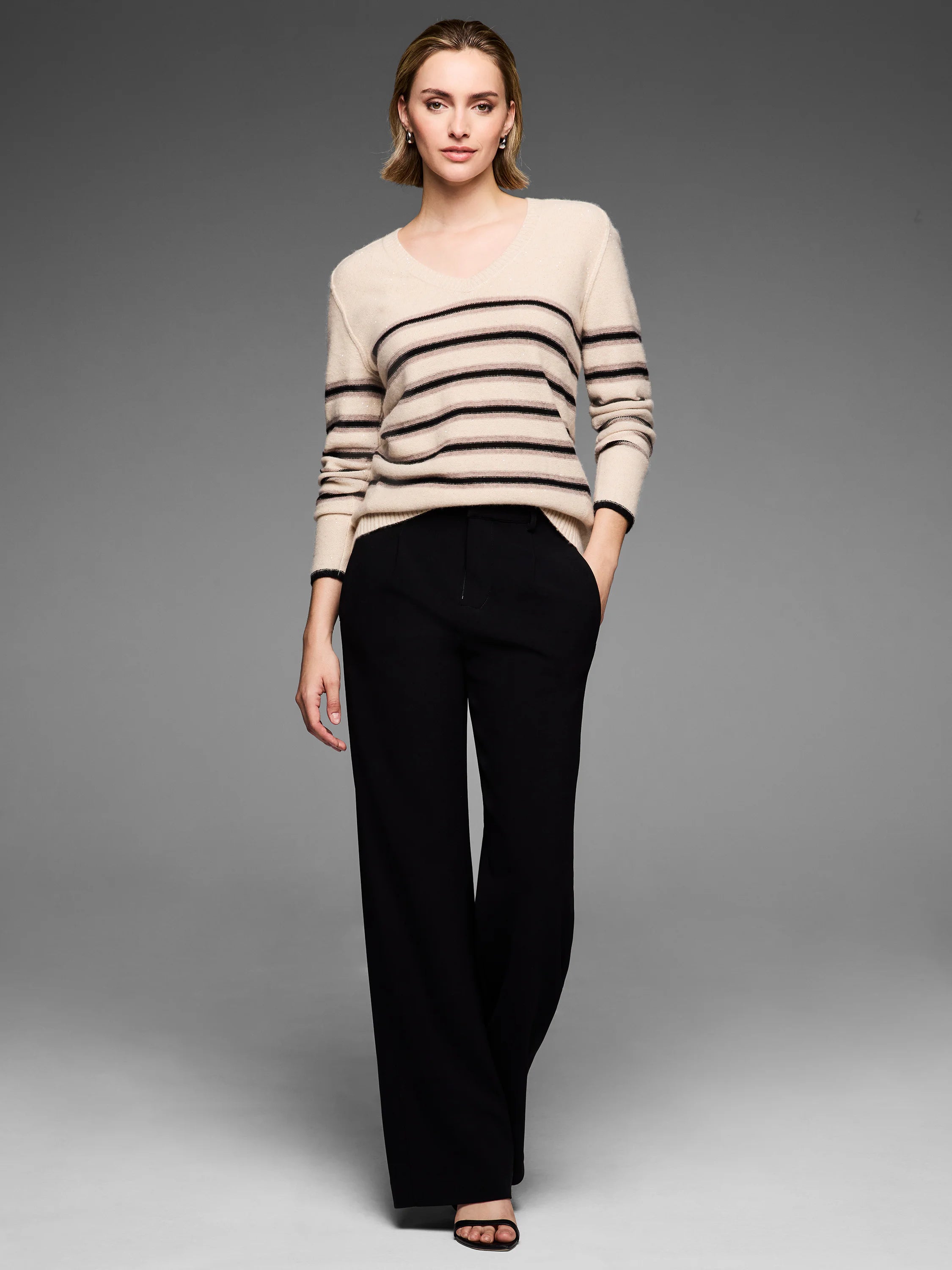 Cream V-neck sweater with black & light horizontal stripes, subtle sparkle.