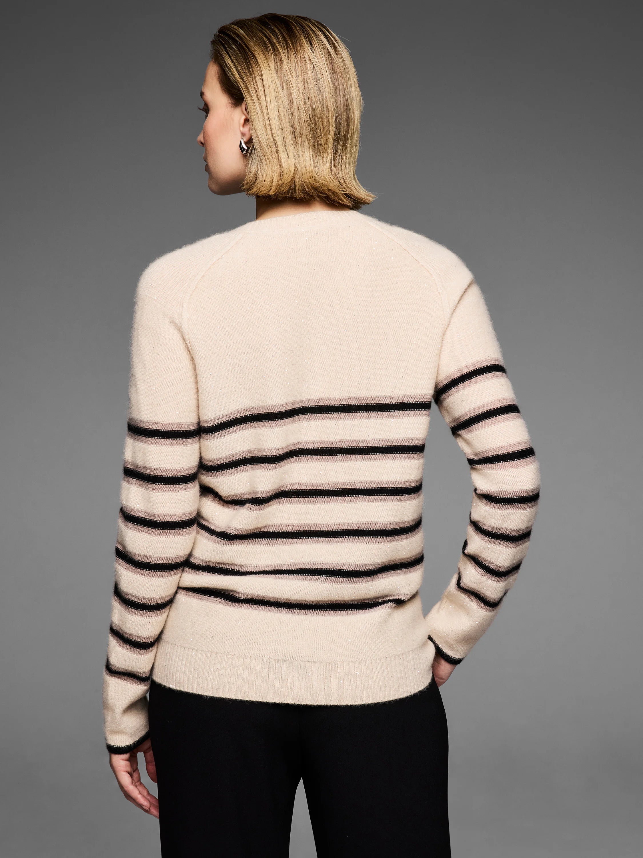 Beige knit sweater with black & taupe horizontal stripes and small visible sparkles throughout.