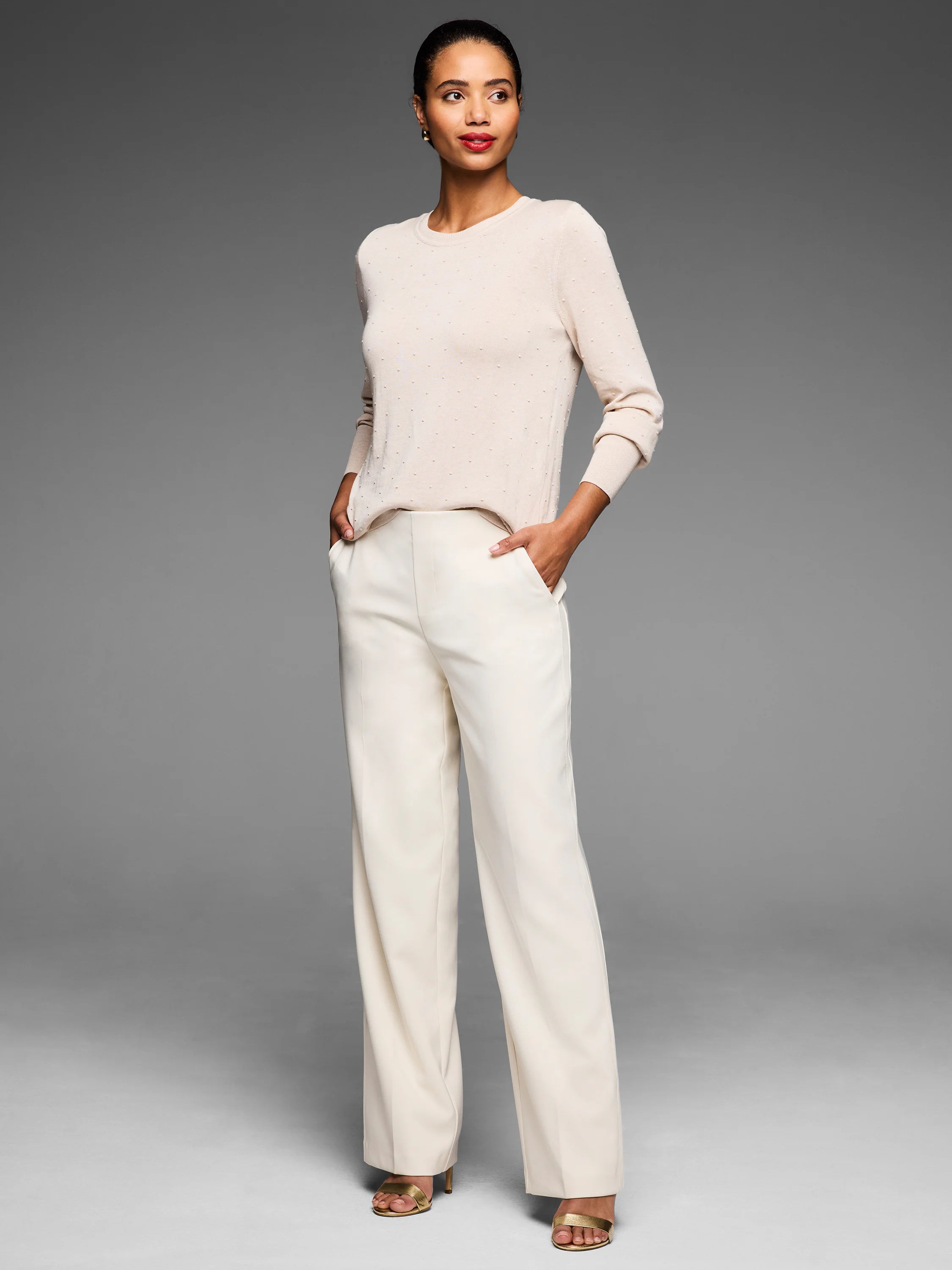 Cream long-sleeve crew neck sweater with raised dot texture.