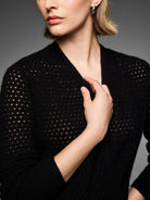 Black cashmere pointelle knit cardigan, featuring small openwork holes throughout the fabric.