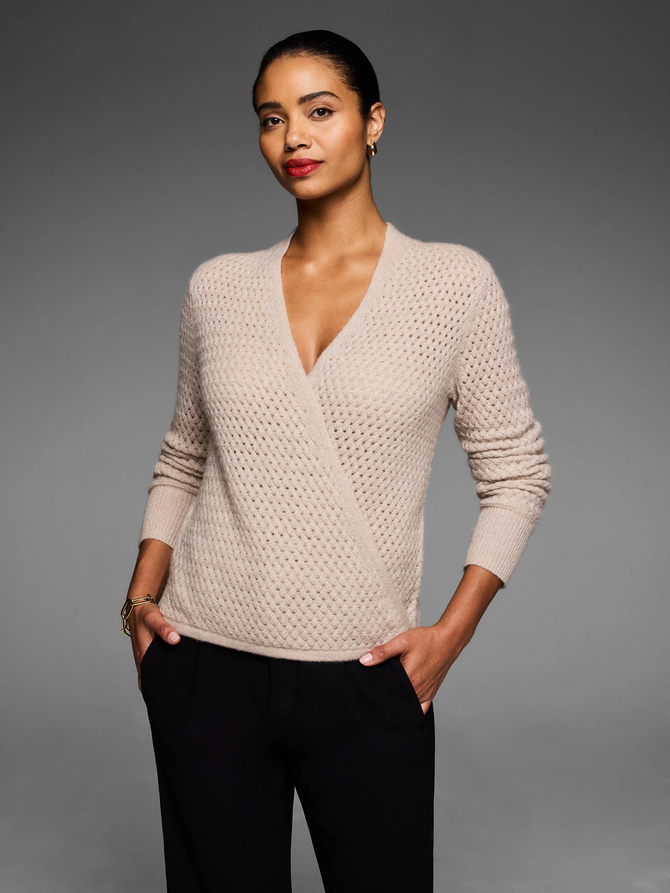 Light beige pointelle knit wrap cardigan with deep V-neck and ribbed cuffs.