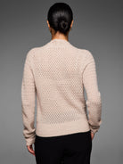 Back view of natural beige pointelle knit cardigan. Features openwork pattern, ribbed cuffs and hem.