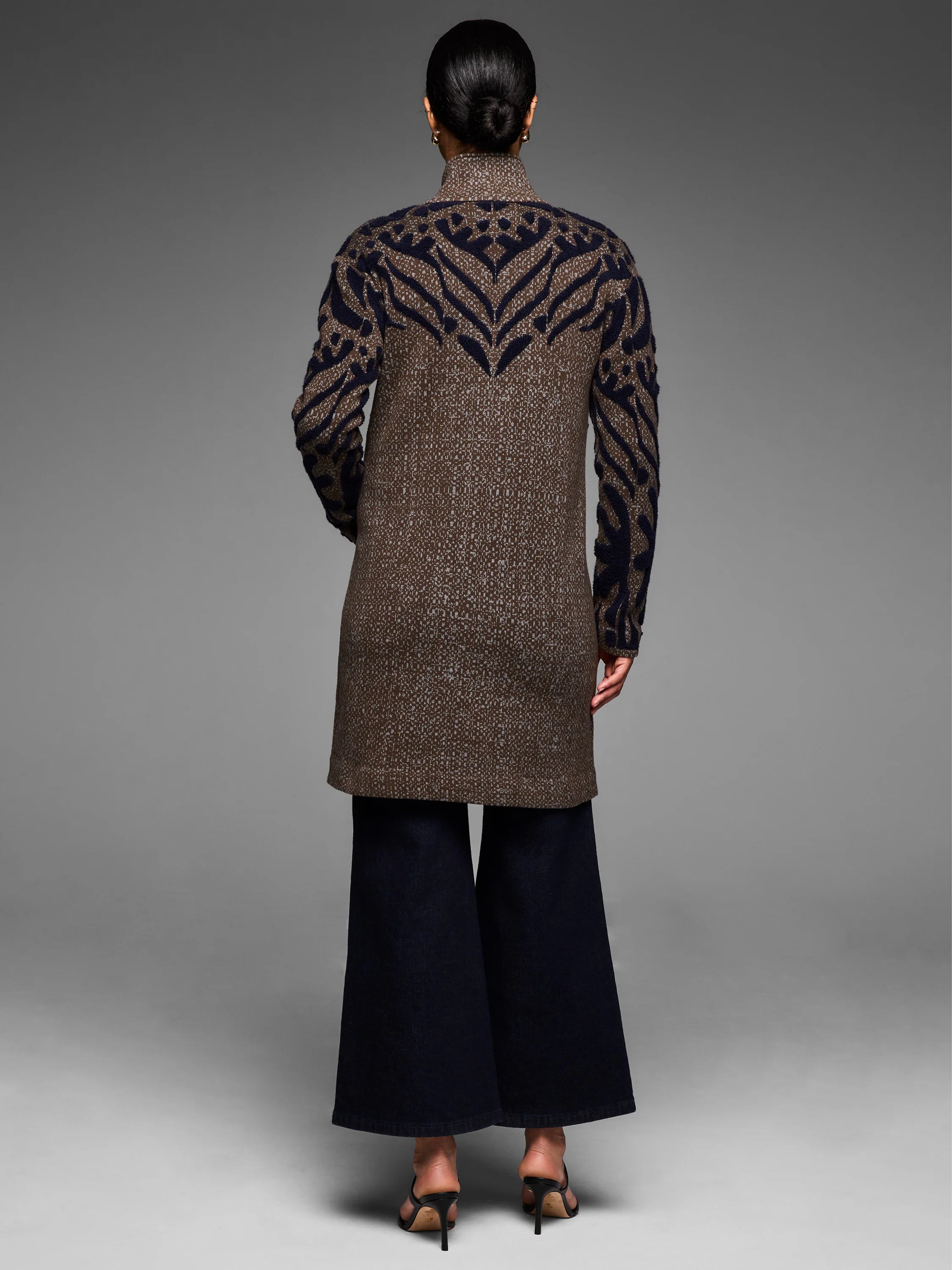 Tufted double knit coat, brown with navy geometric pattern on collar, shoulders, and sleeves.