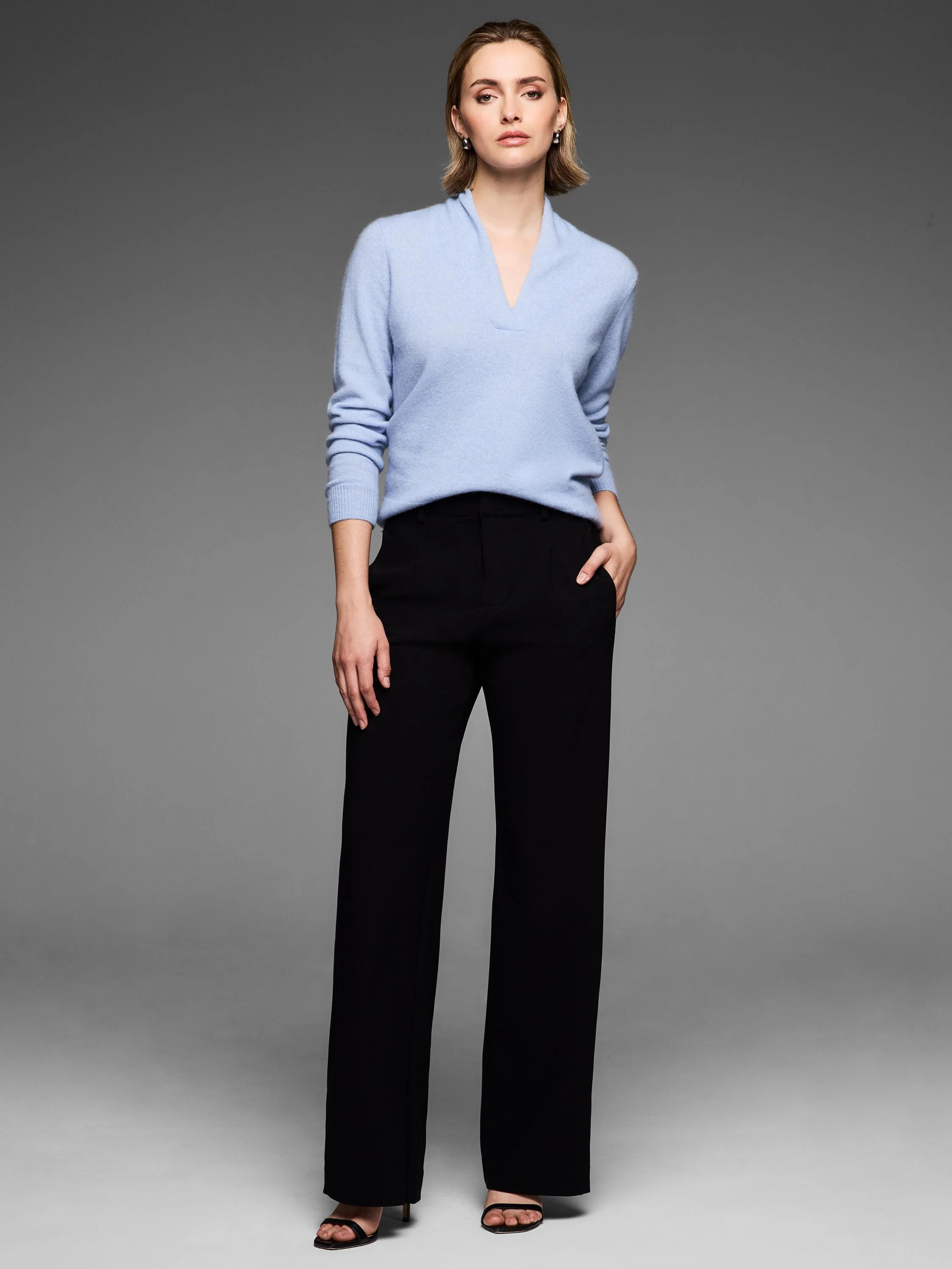 Light blue cashmere sweater with a V-neck and long sleeves.