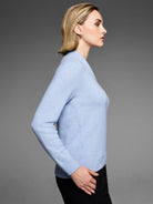 Pastel blue fuzzy sweater with built-up neck, ribbed cuffs, and hem.