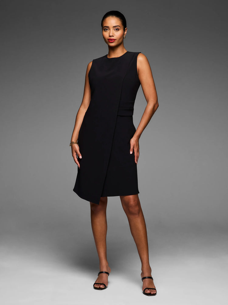 Black sleeveless dress with a round neck, angled knee-length skirt, and a front overlap detail.