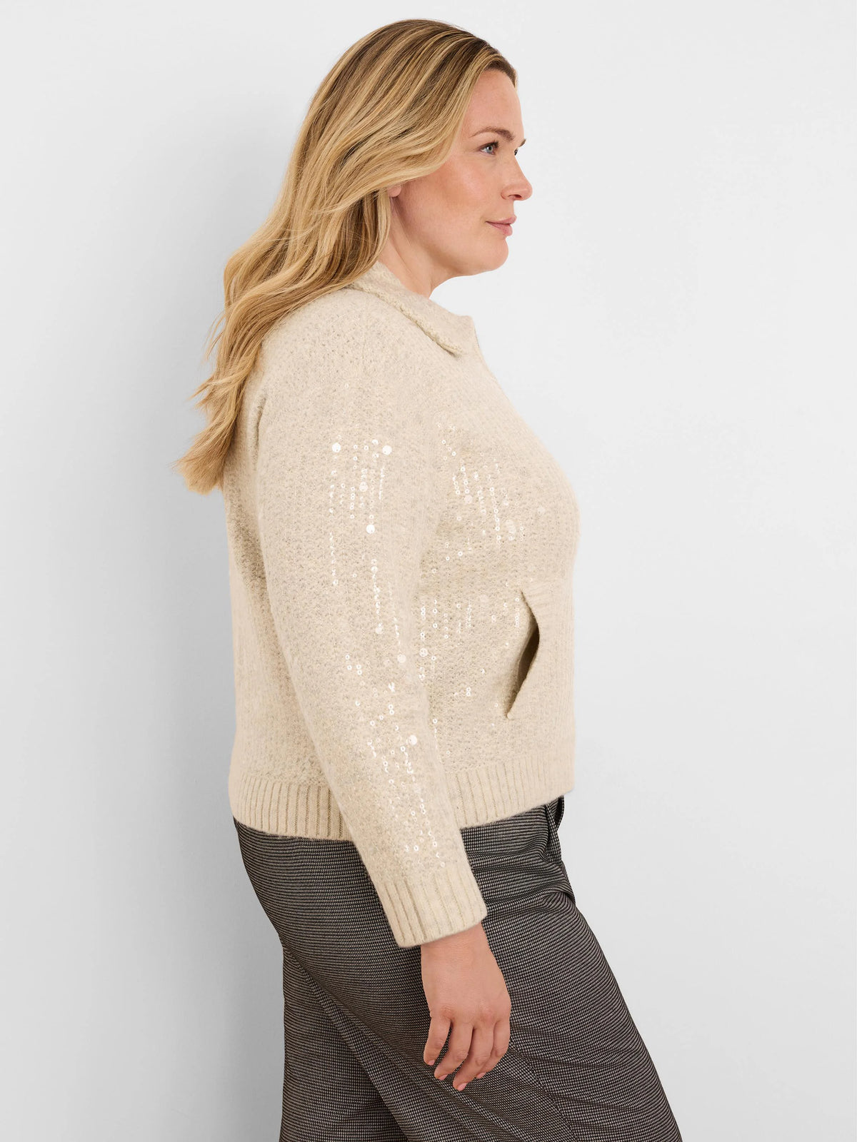 Cream knit jacket with clear sequins throughout, a spread collar, ribbed cuffs, and a side pocket.