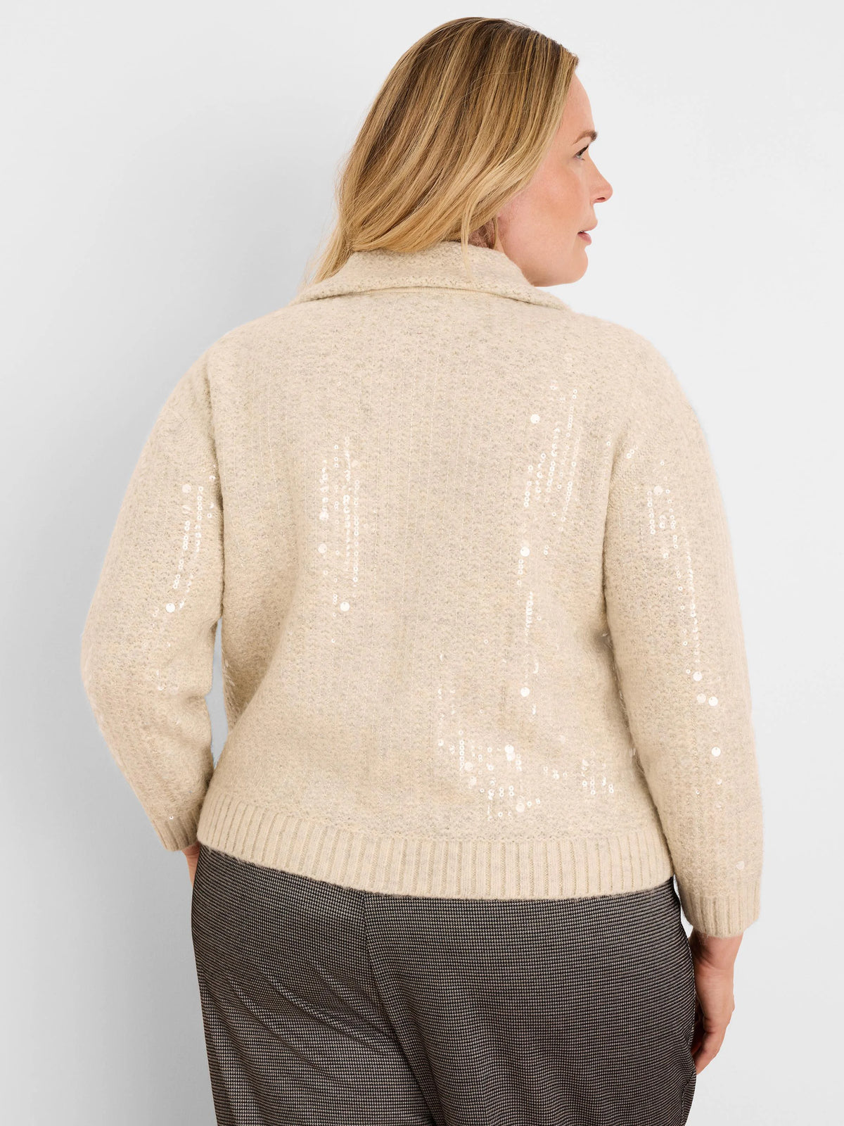Light beige knit jacket with collar, ribbed cuffs/hem, and vertical lines of clear sequins.