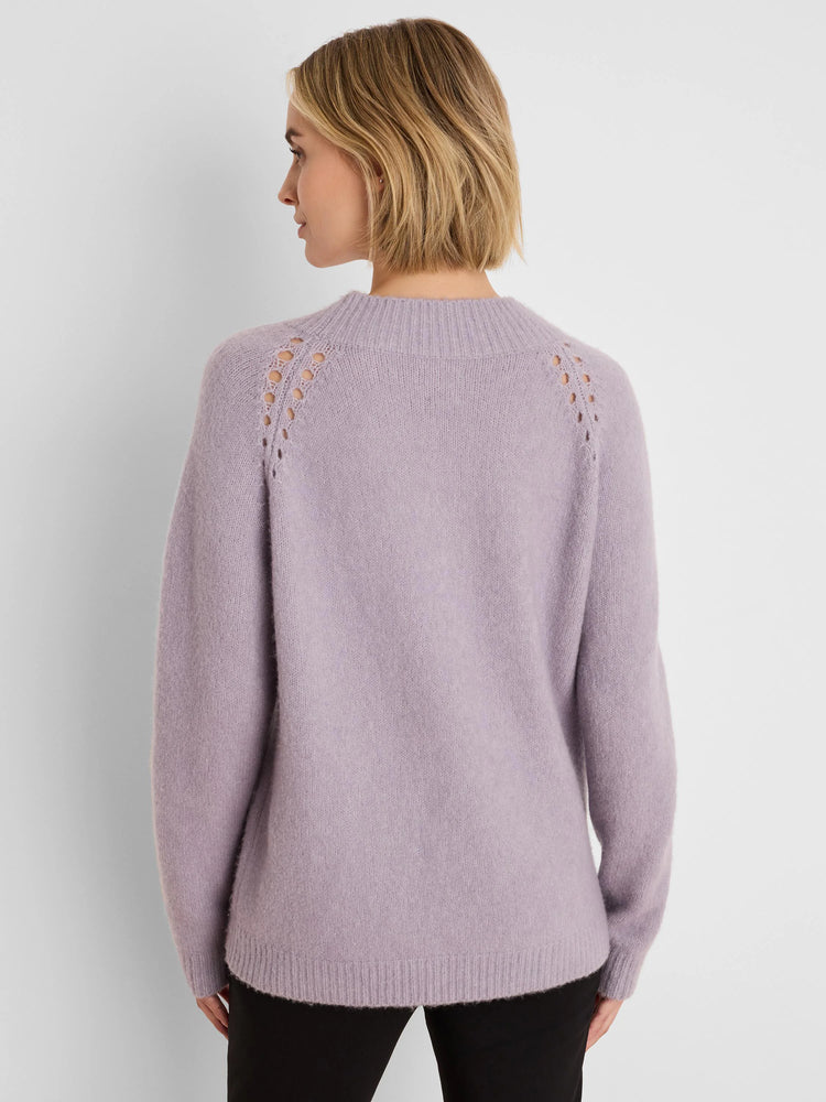 Back view: Lavender fuzzy sweater with ribbed mock neck and decorative eyelets along the raglan shoulders.