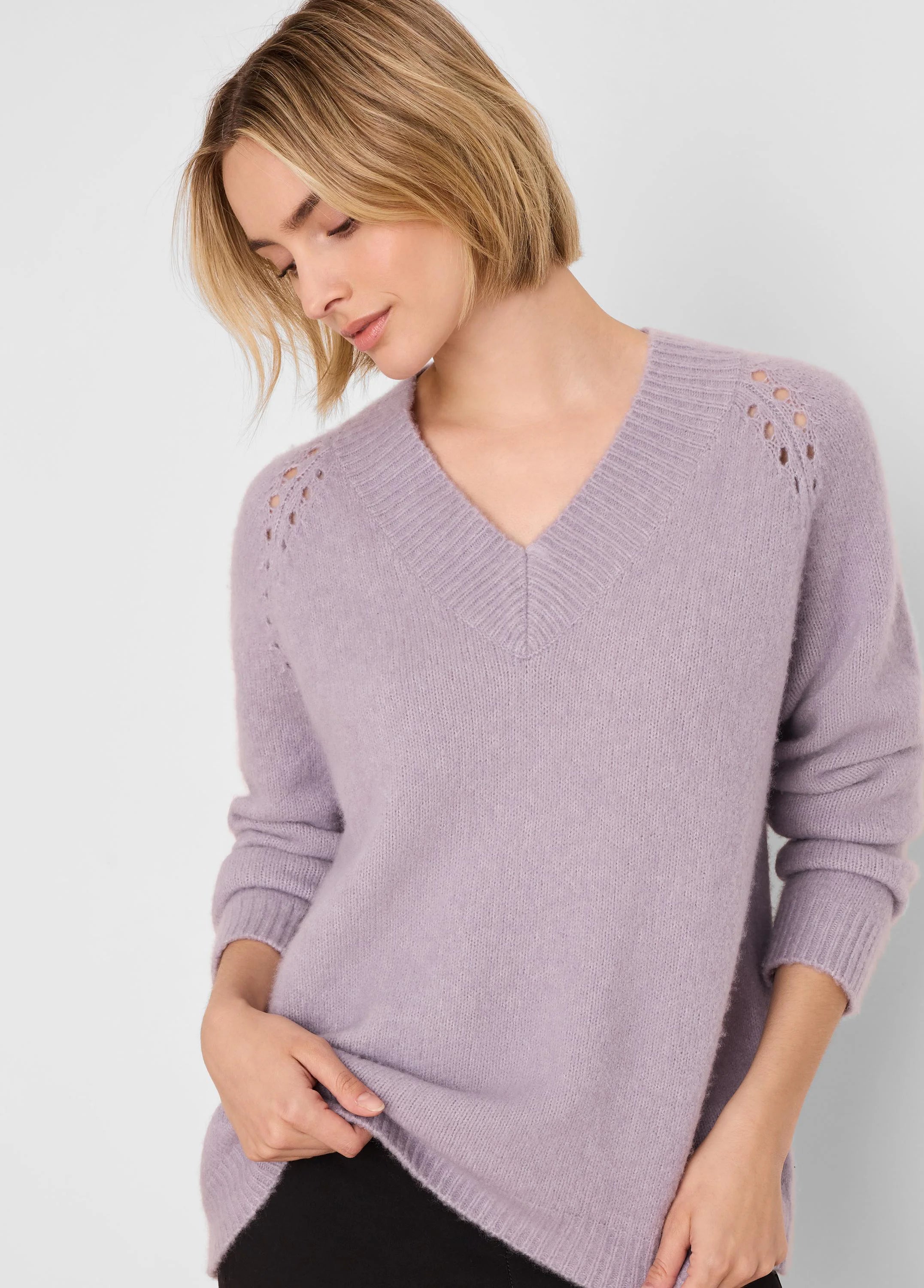 Light lavender V-neck sweater with ribbed trim and delicate eyelet details on shoulders.