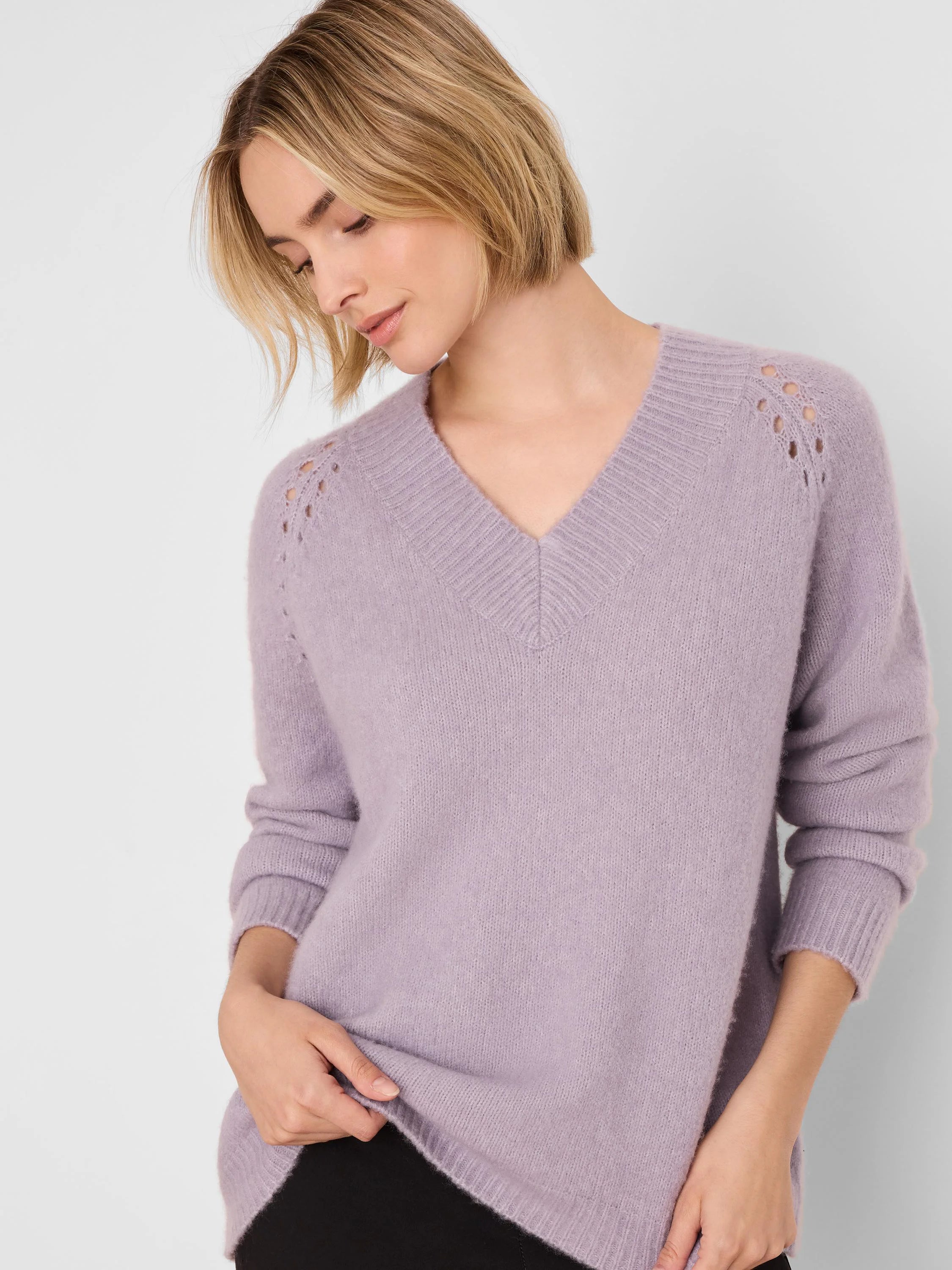 Light lavender V-neck sweater with ribbed trim and delicate eyelet details on shoulders.